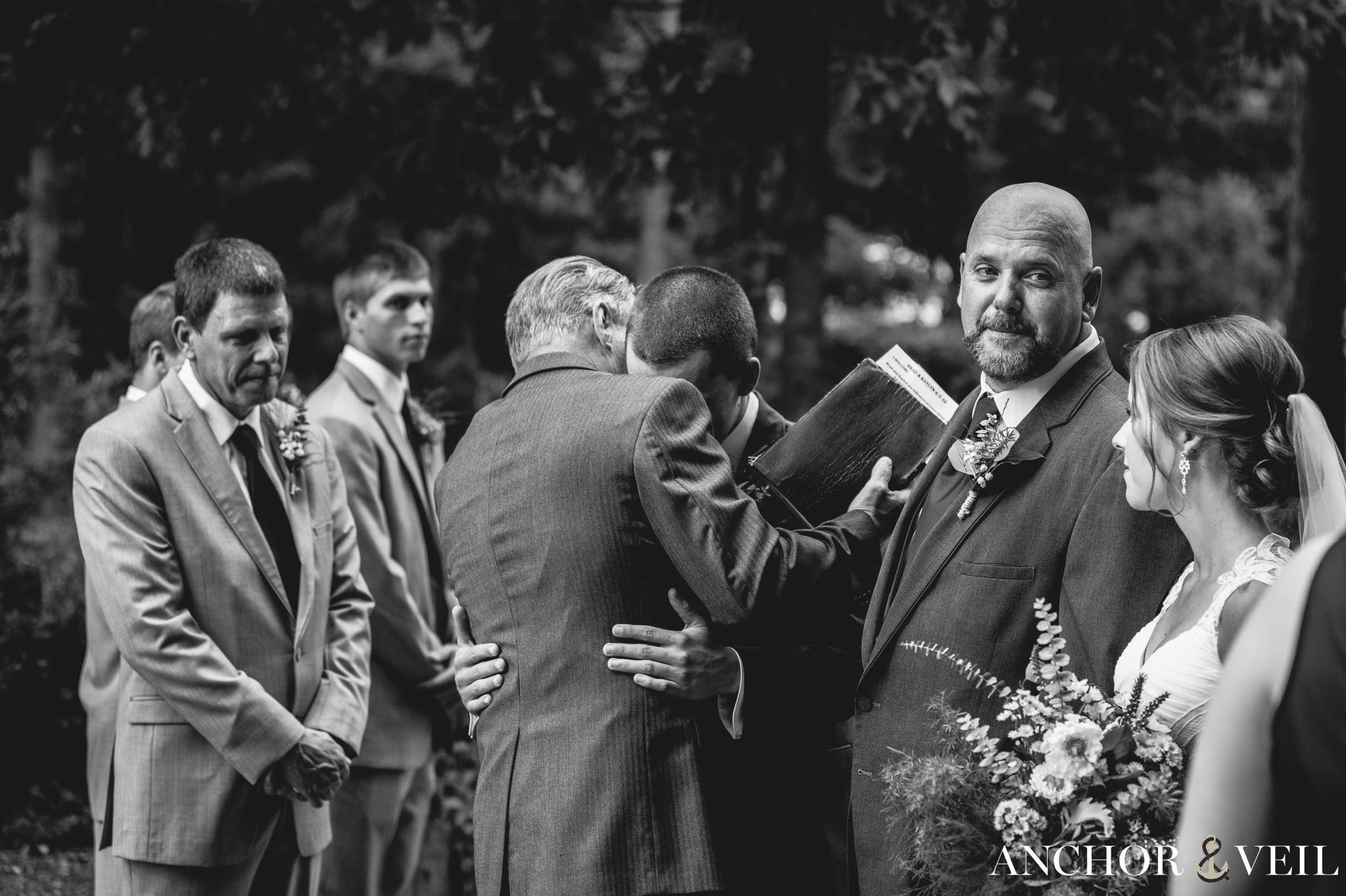 groom crying with the officiant
