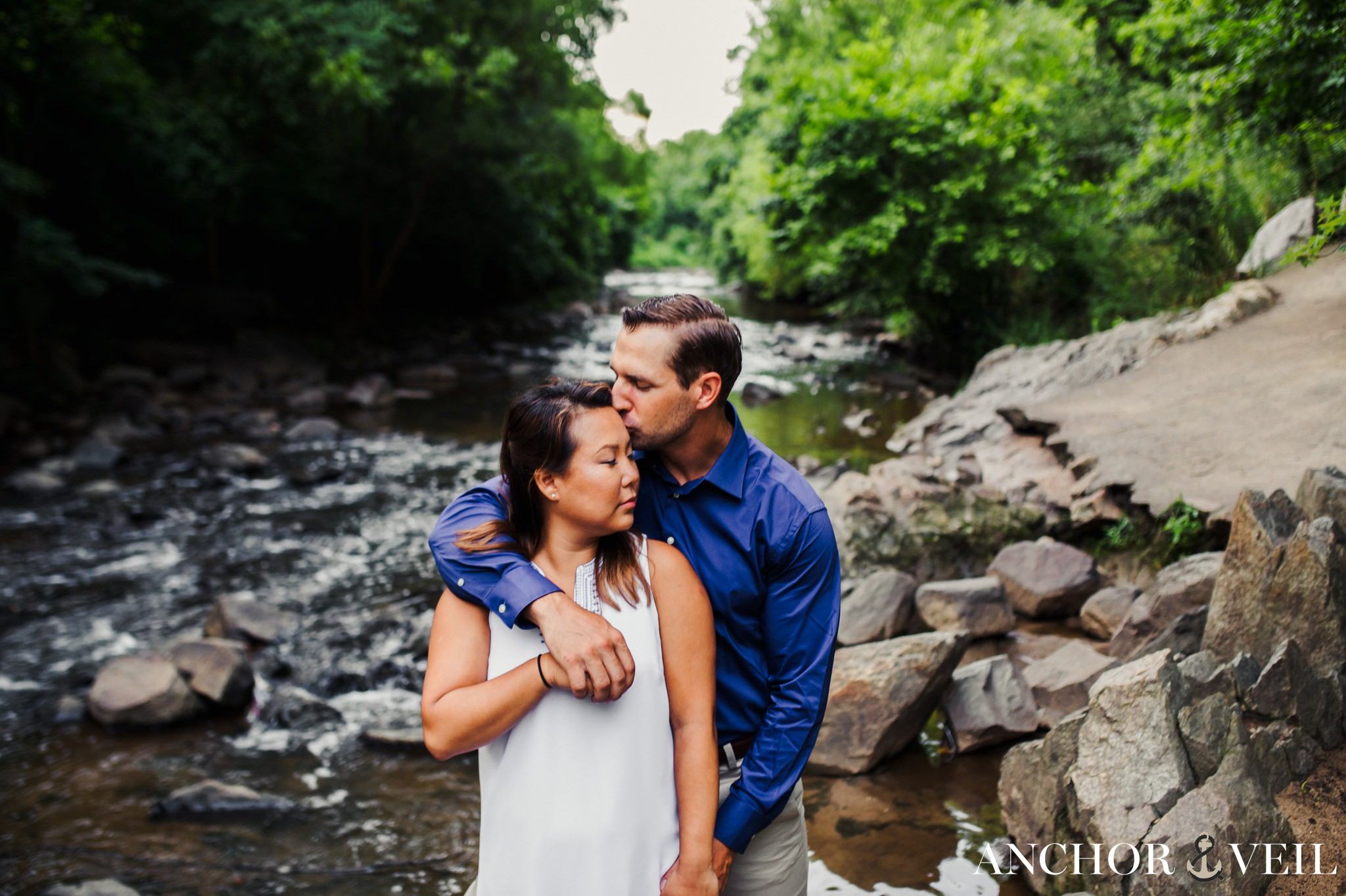 standing the river holding each other during their Freedom Park Engagement Session