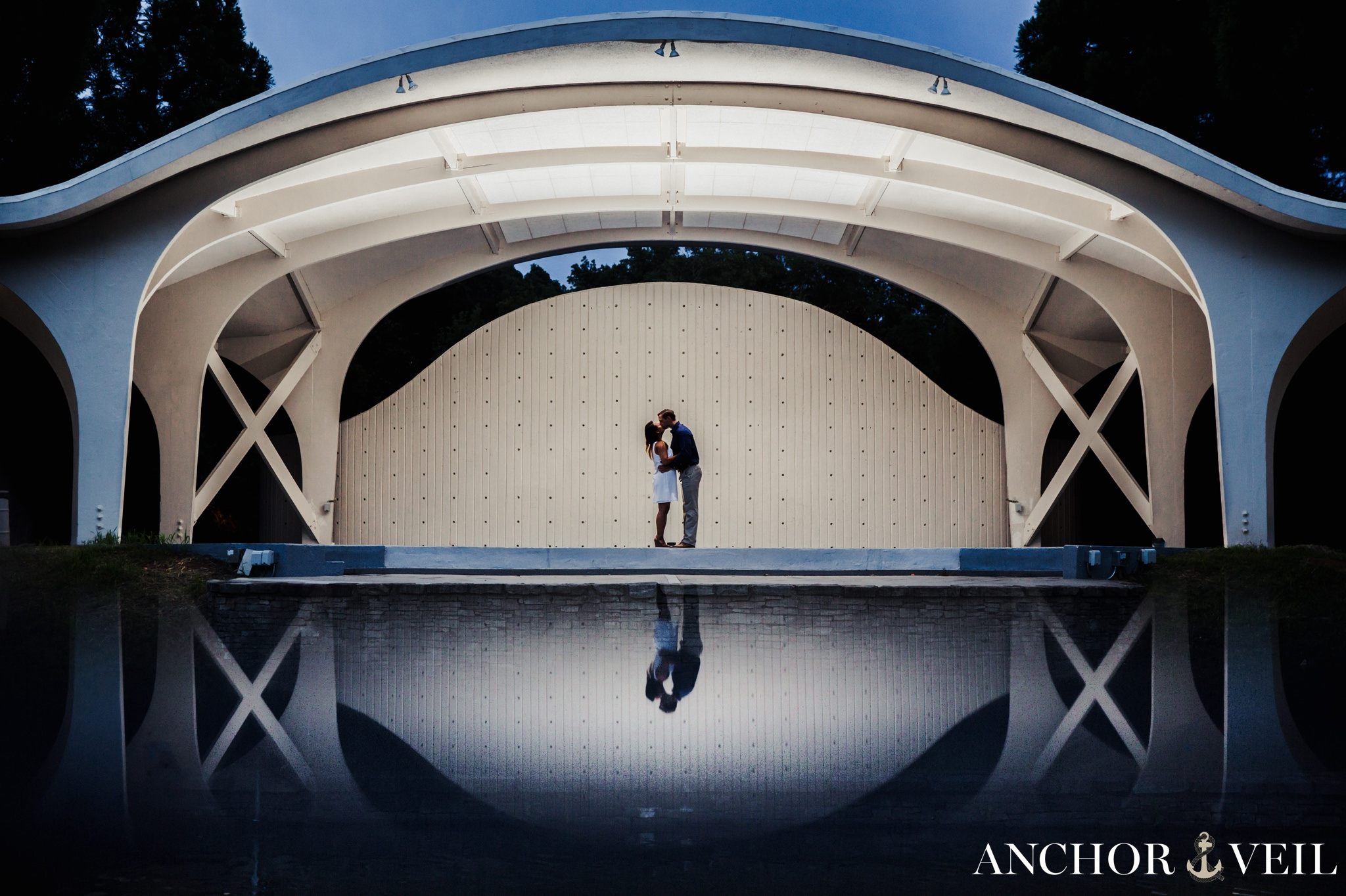 standing in the amphitheater reflection of the couple during their Freedom Park Engagement Session