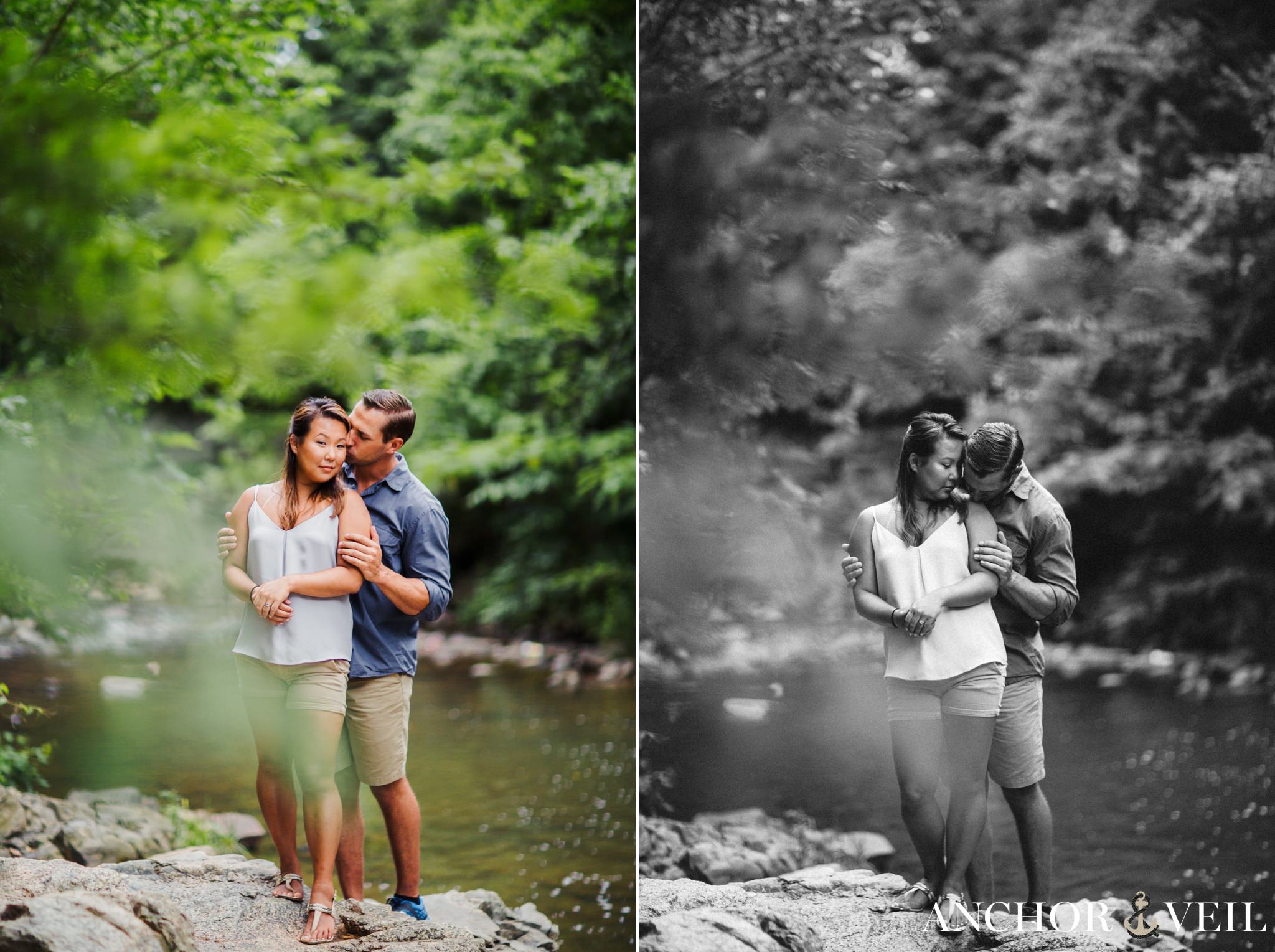 sweet lovers' embrace and kiss standing on rocks during their Freedom Park Engagement Session