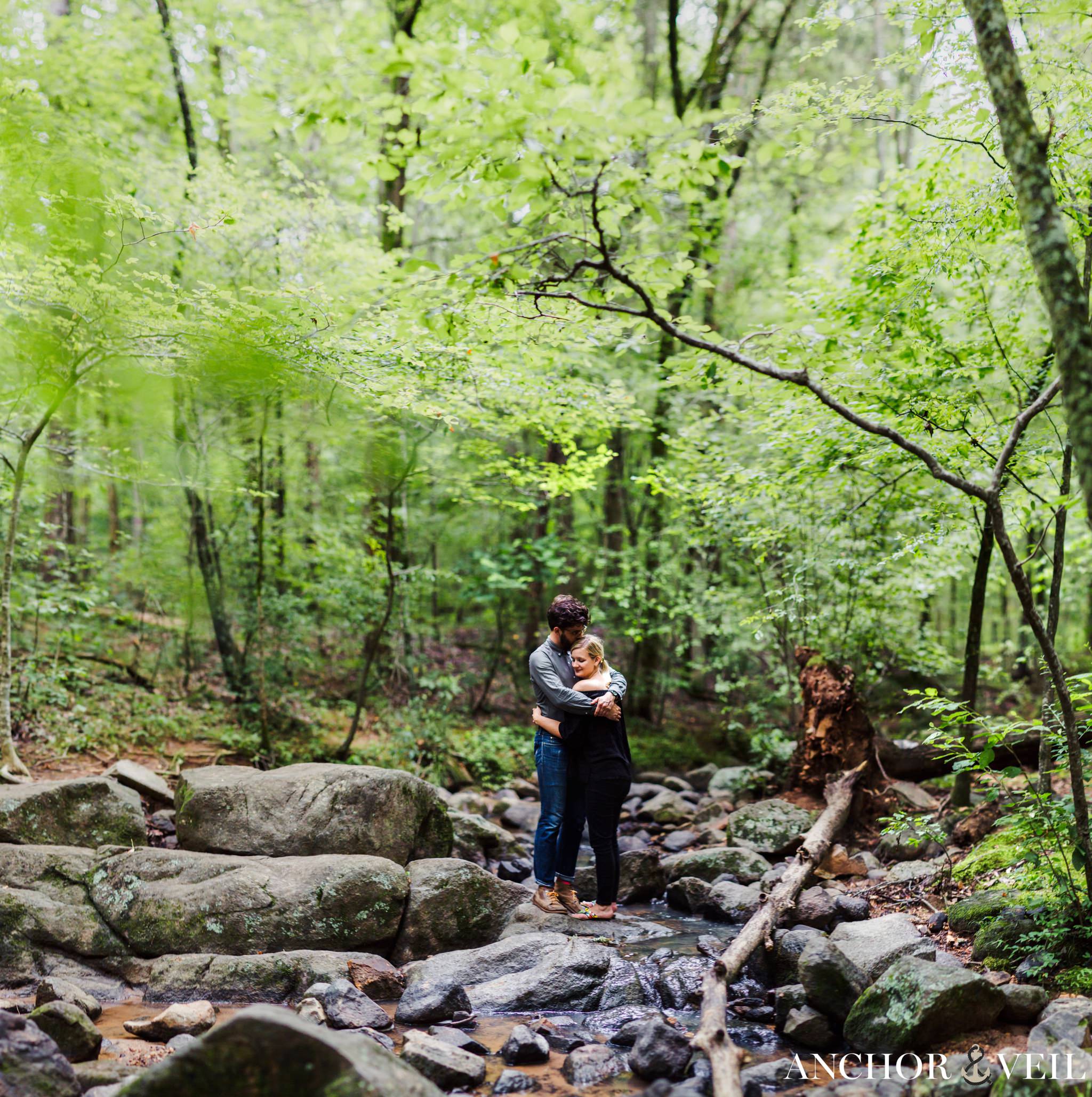 brenizer method on the rocks in the woods during their McDowell Nature Preserve Engagement Session