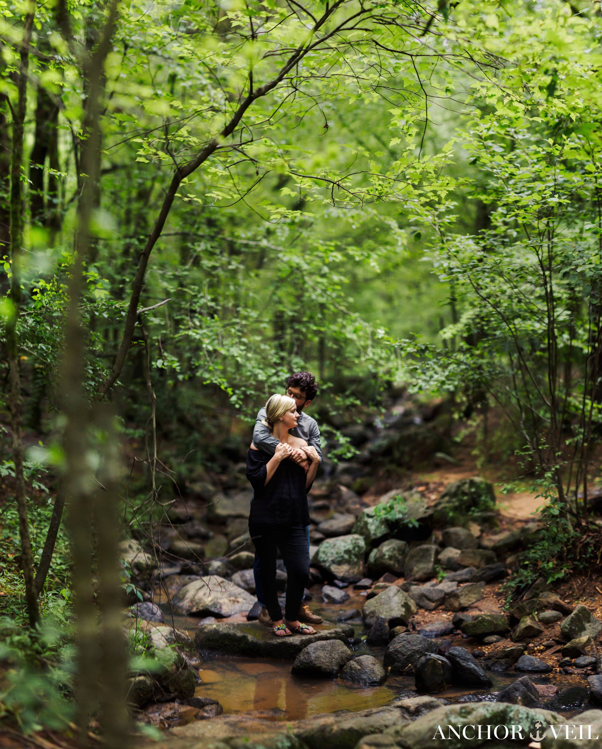 brenizer method standing on the rocks in the McDowell Nature Preserve Engagement Session
