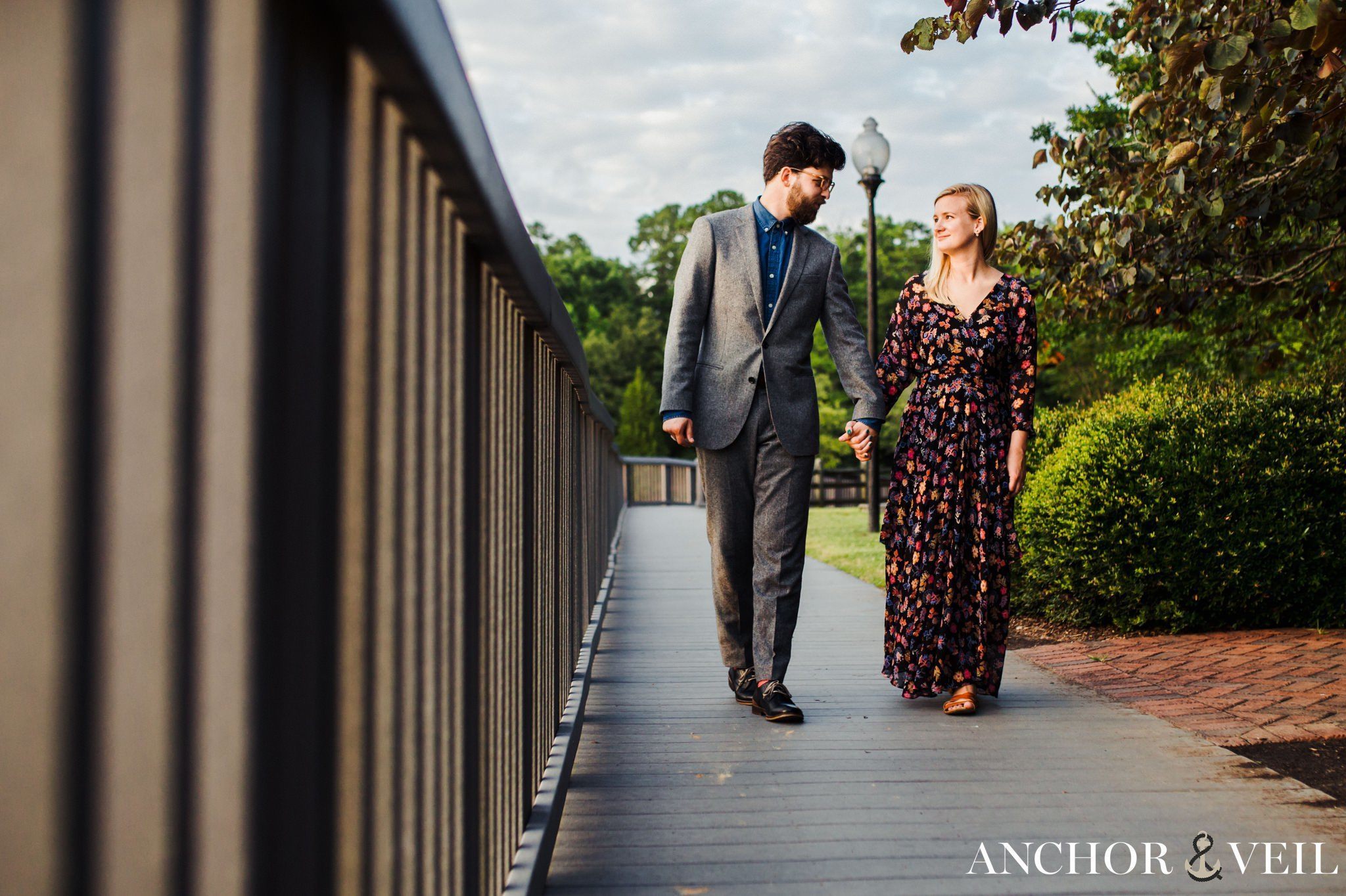 on the wooden walkway together during their McDowell Nature Preserve Engagement Session
