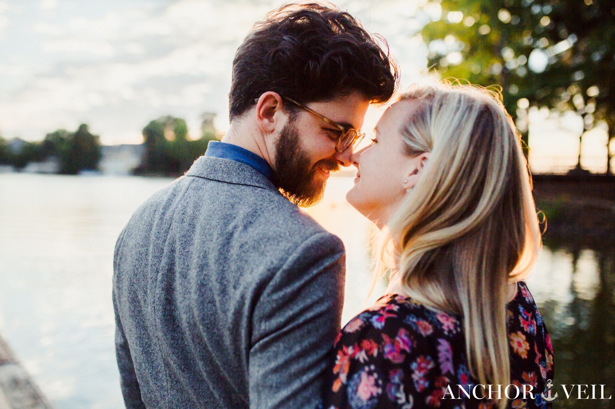 A tender nose to nose with the sunlight behind them during their McDowell Nature Preserve Engagement Session