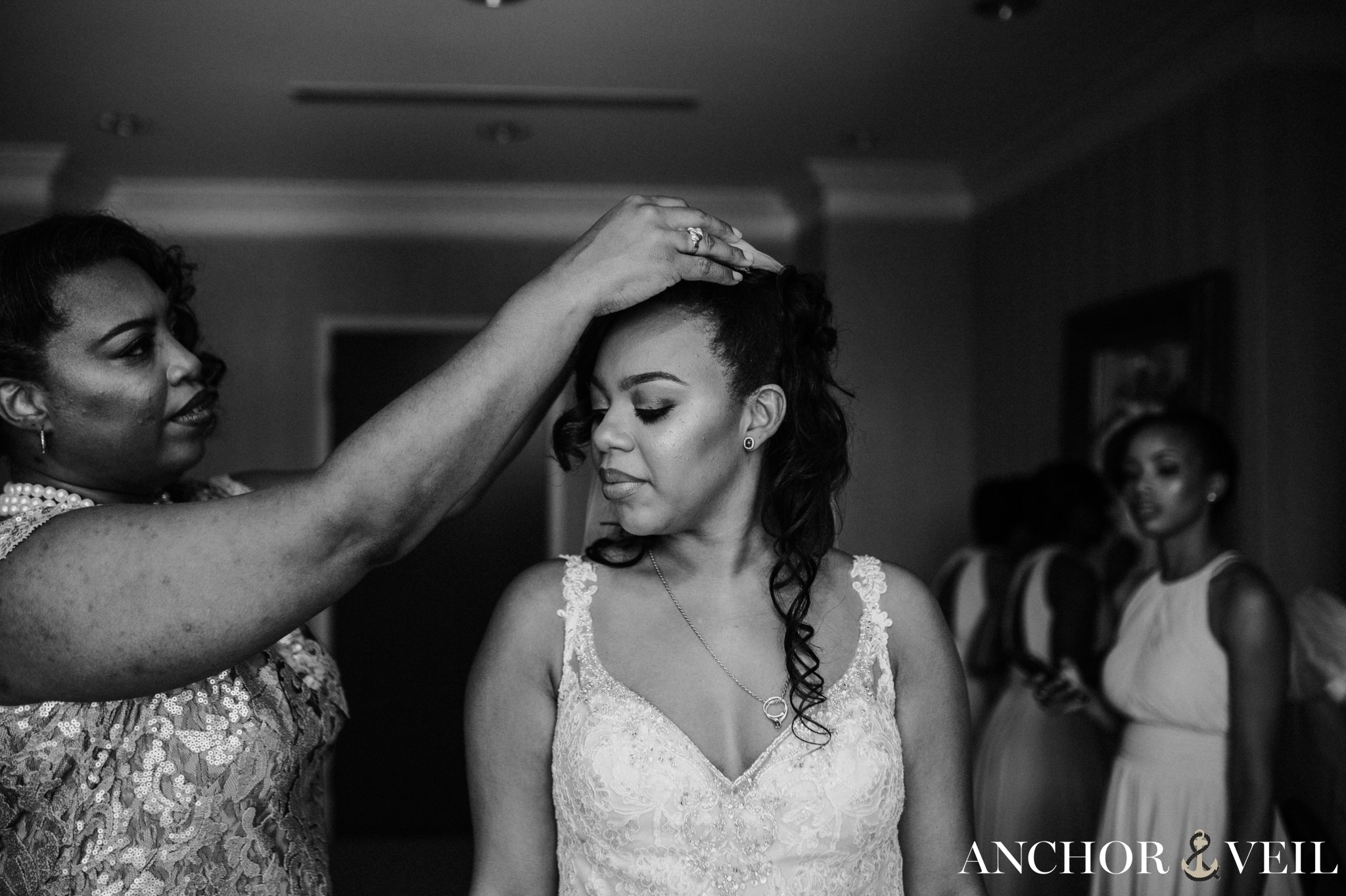 mom helping bride to get ready