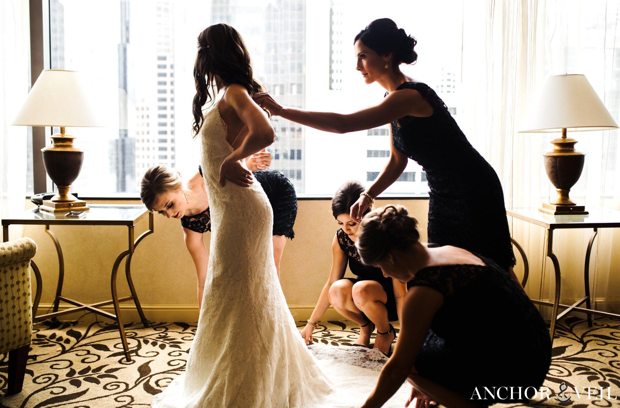 girls helping bride get ready at the omni hotel uptown charlotte 