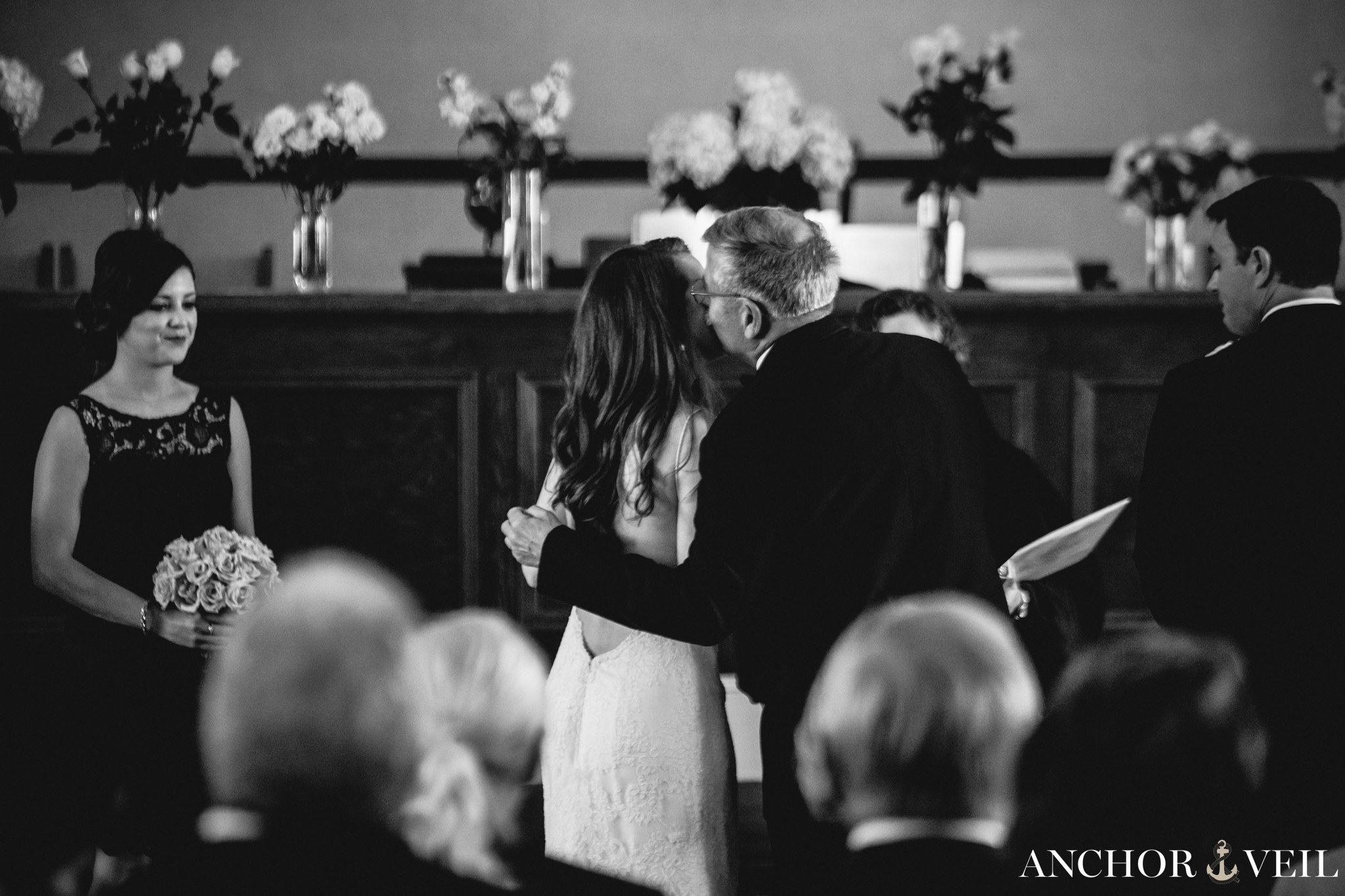 father of the bride kissing the bride