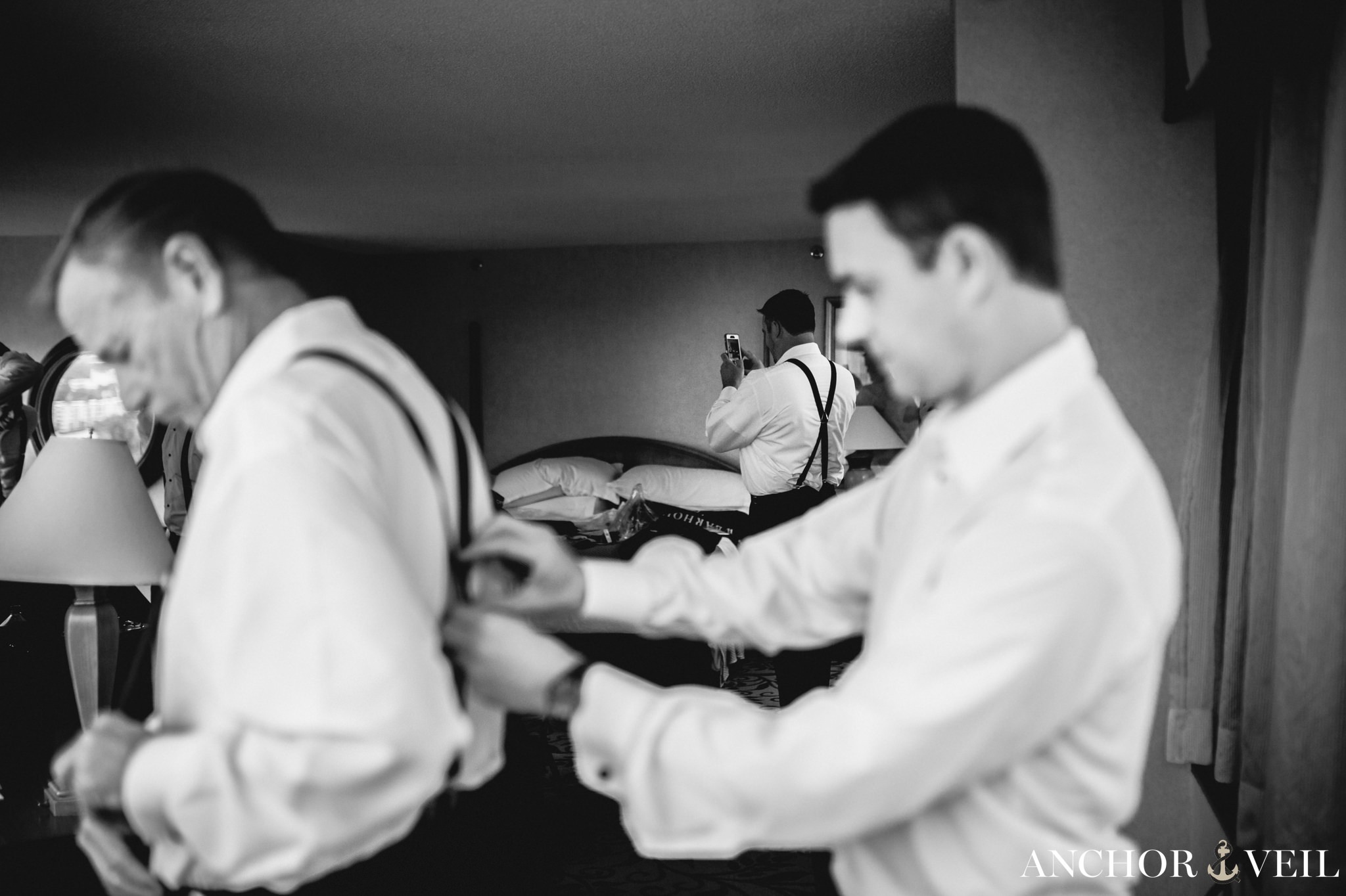 Groom helping father get ready