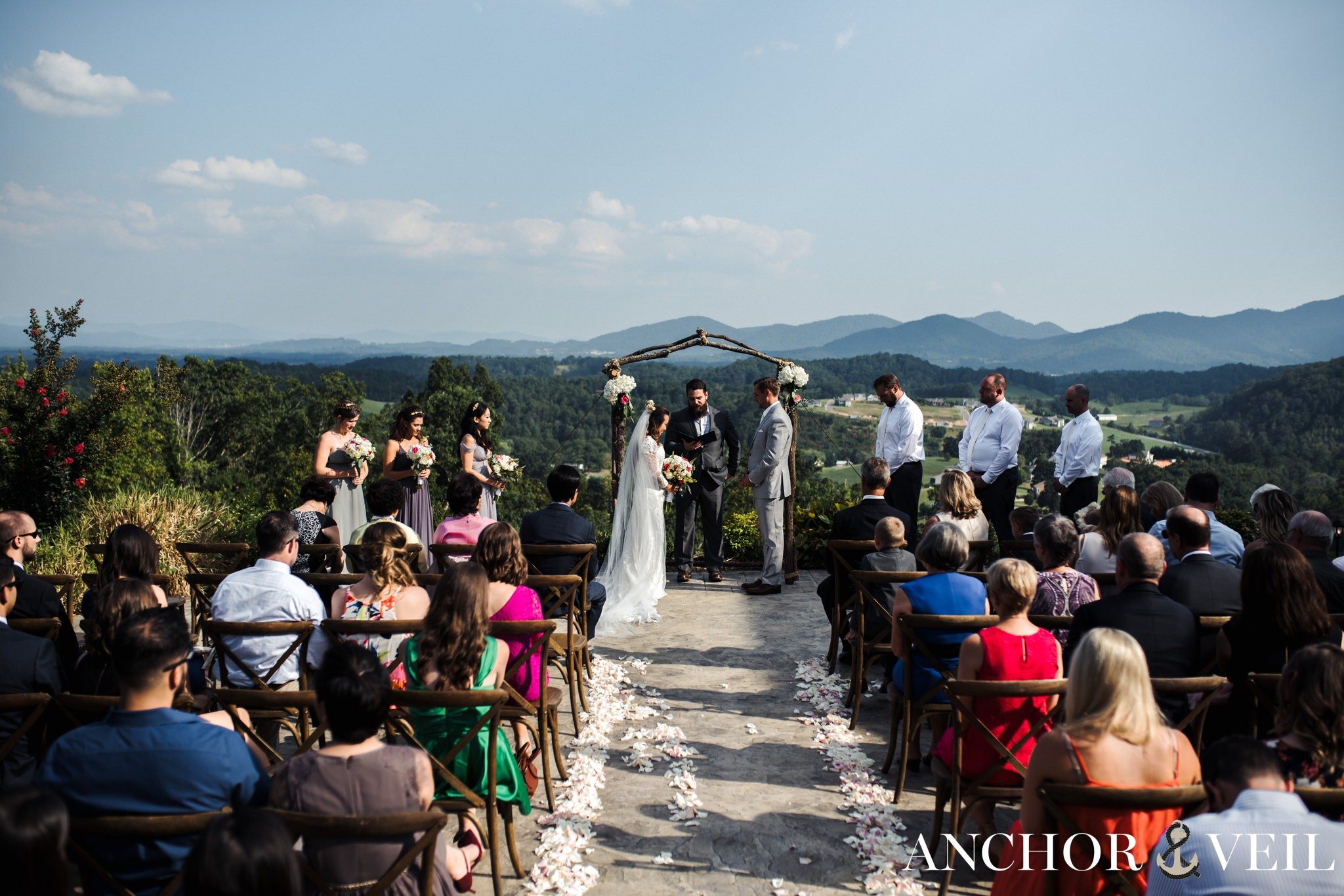 ceremony with the bride and groom with asheville mountains destination wedding