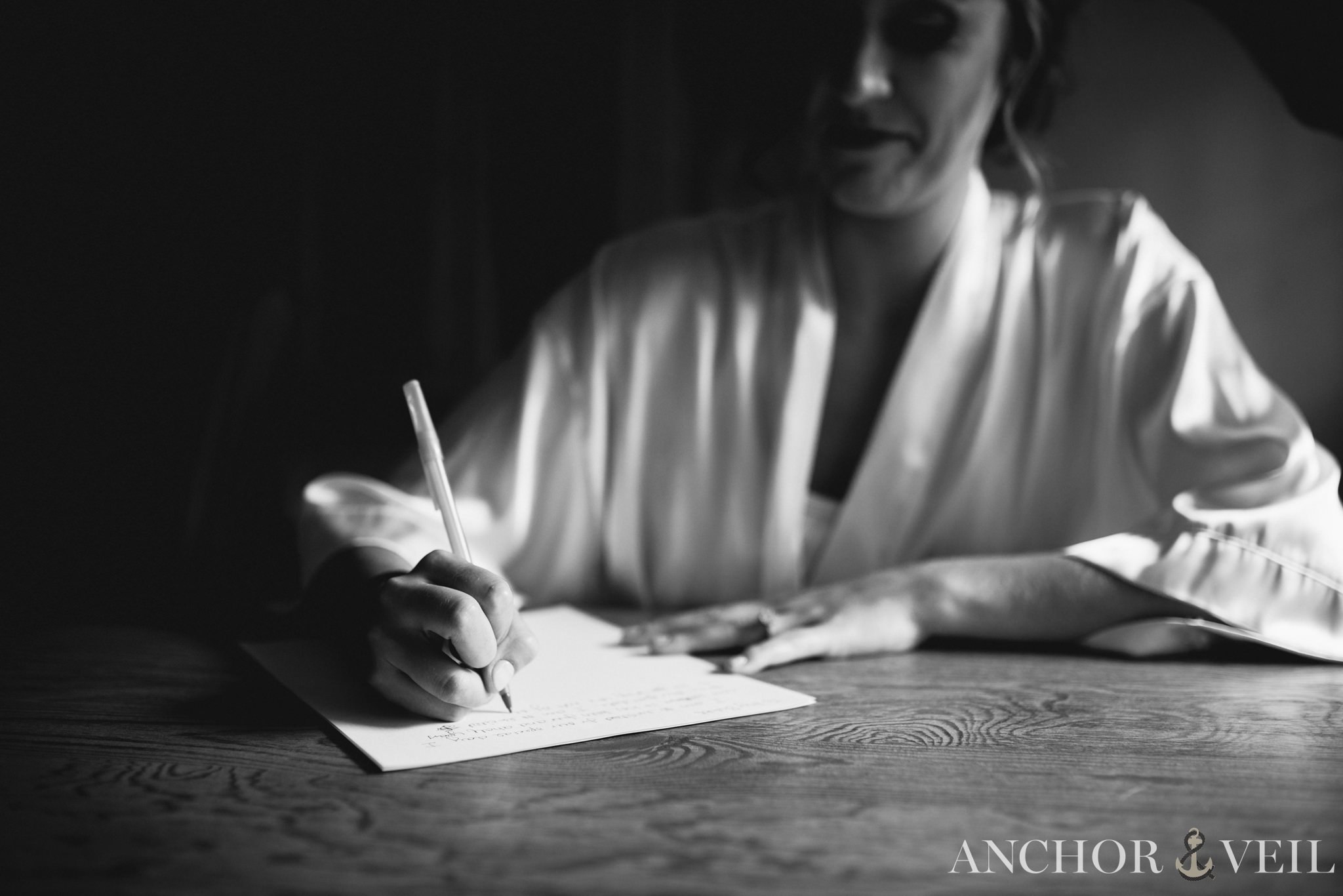 bride writing her letter to the groom before their charlotte wedding