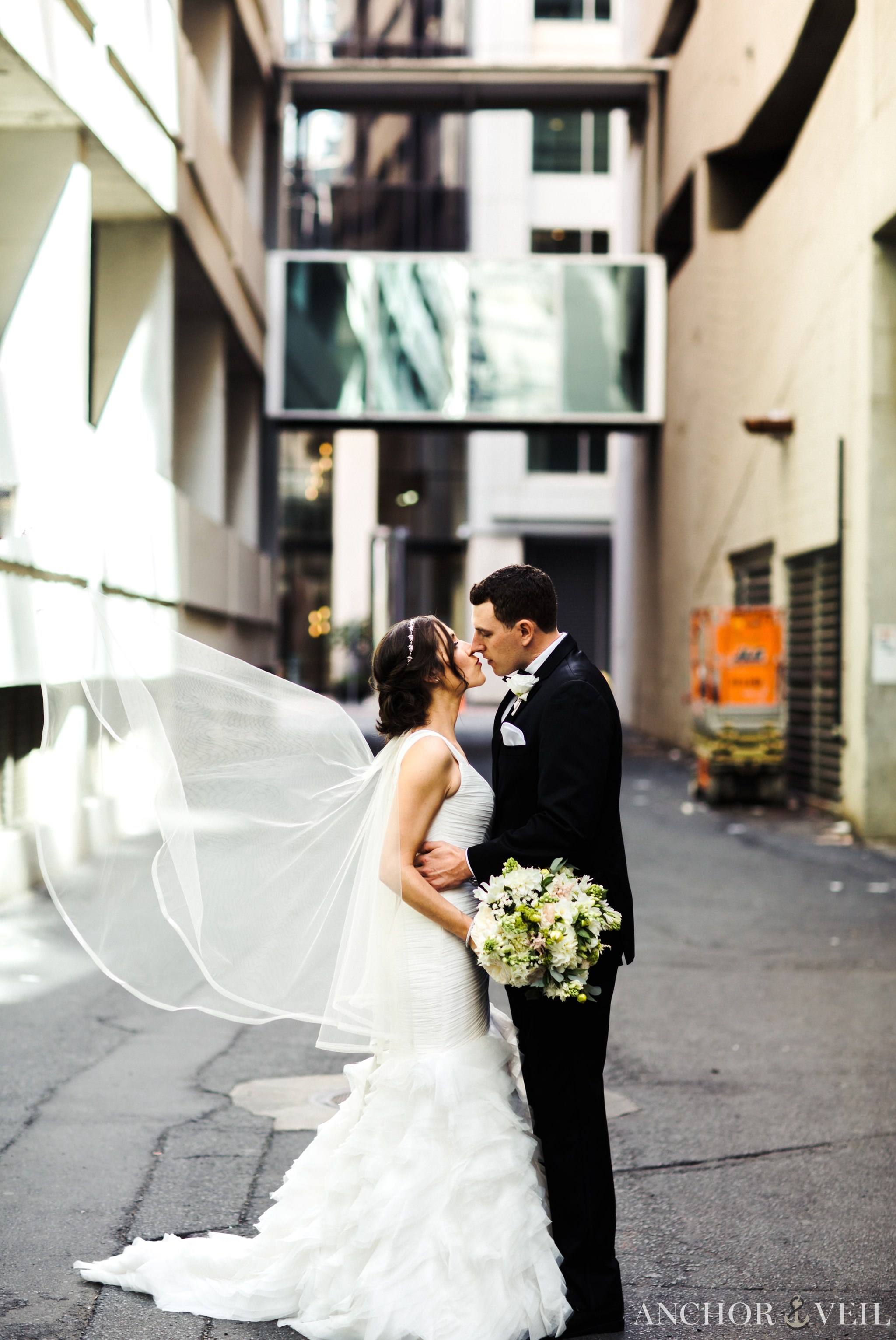 the veil and kiss in the alley during the founders Hall wedding in Charlotte Nc