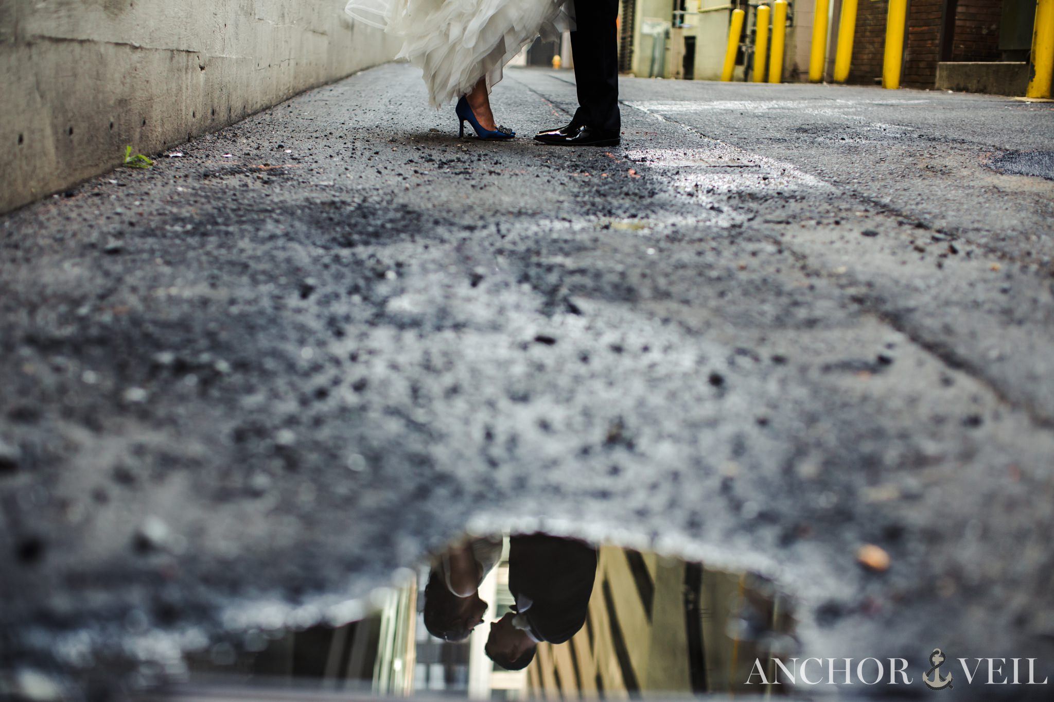 shooting in the puddle while they kiss in the founders Hall wedding in Charlotte Nc