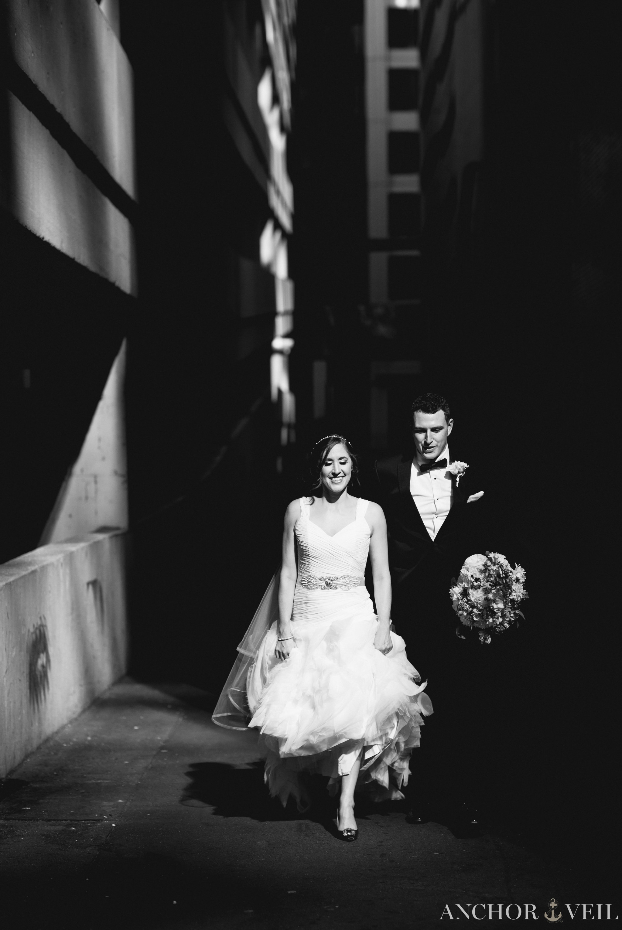 walking out of the alley in the dramatic light founders Hall wedding in Charlotte Nc