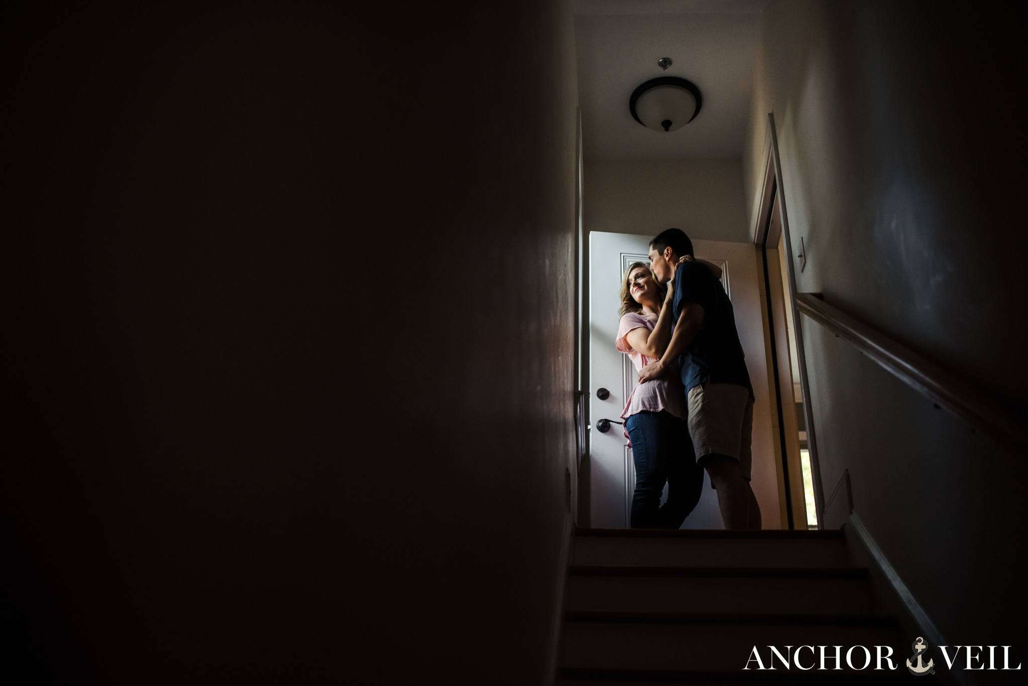 in the stairway close together during the In Home Charlotte Engagement Session