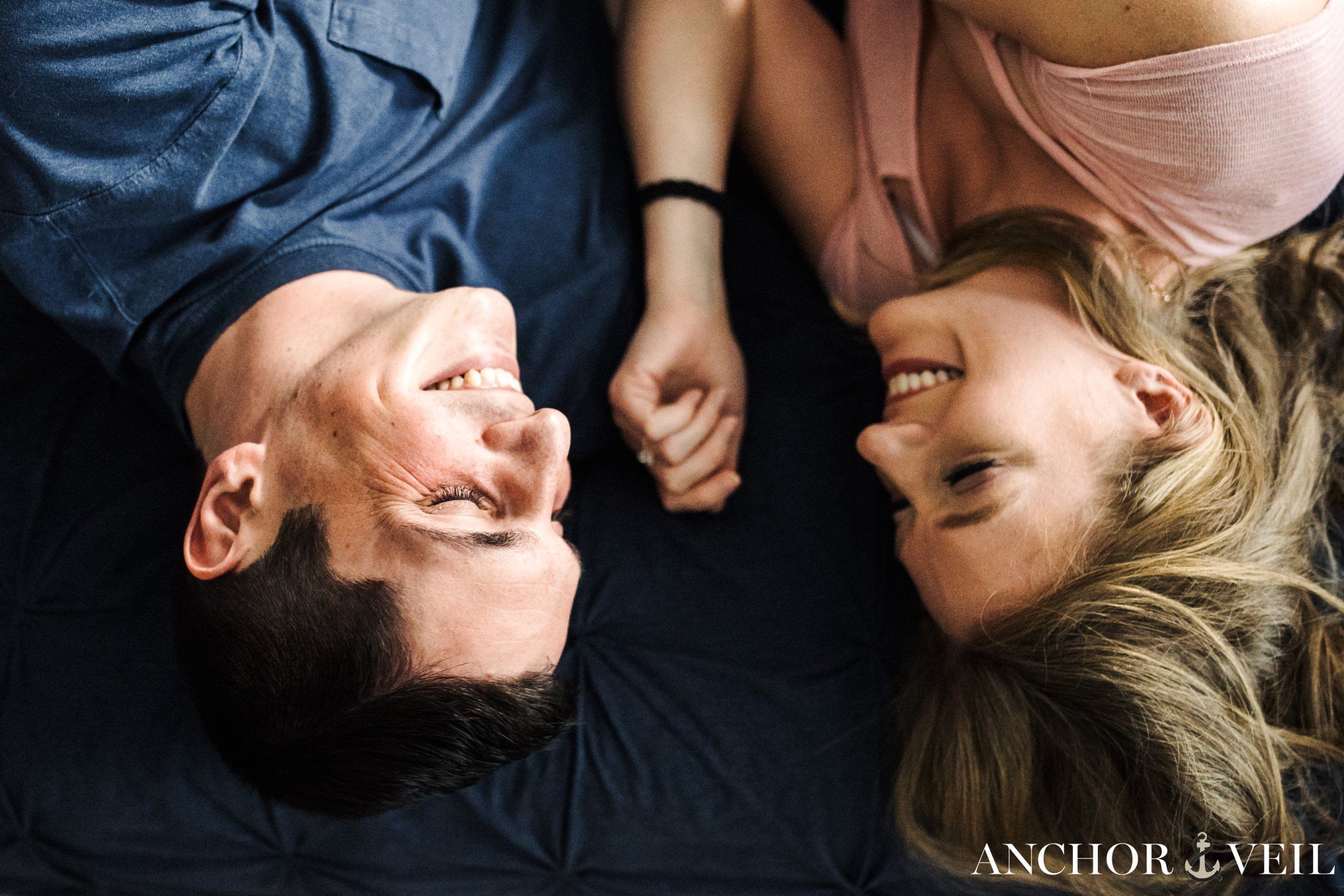 laughs on the bed during the In Home Charlotte Engagement Session