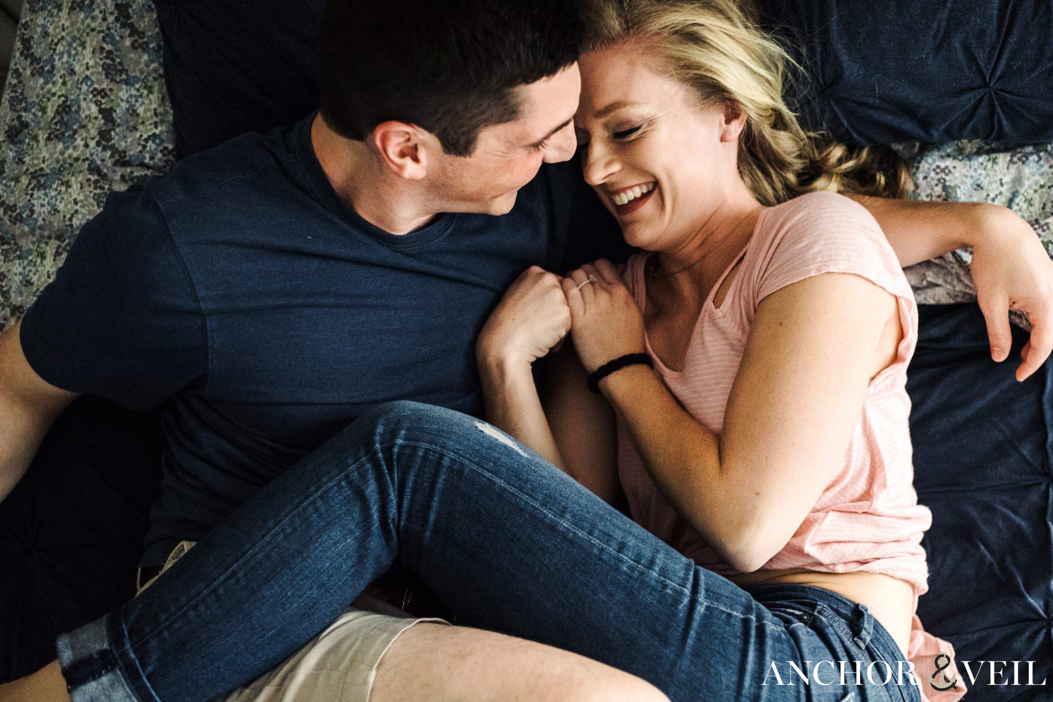 tickling and laughing on the bed during the In Home Charlotte Engagement Session