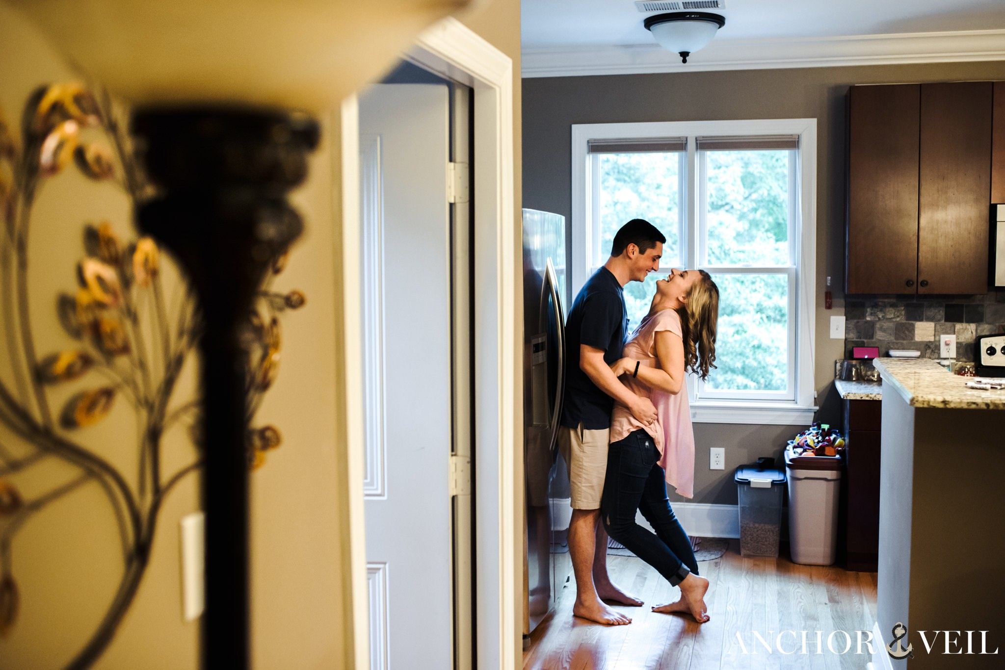 up against the fridge during the In Home Charlotte Engagement Session