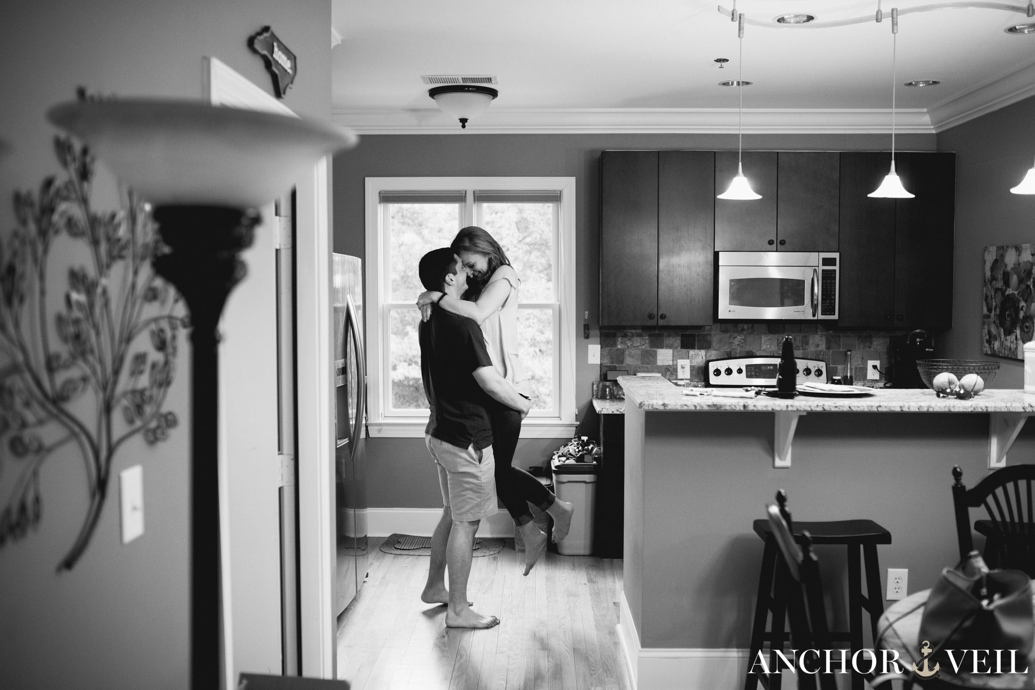 picking her up in the kitchen during the In Home Charlotte Engagement Session