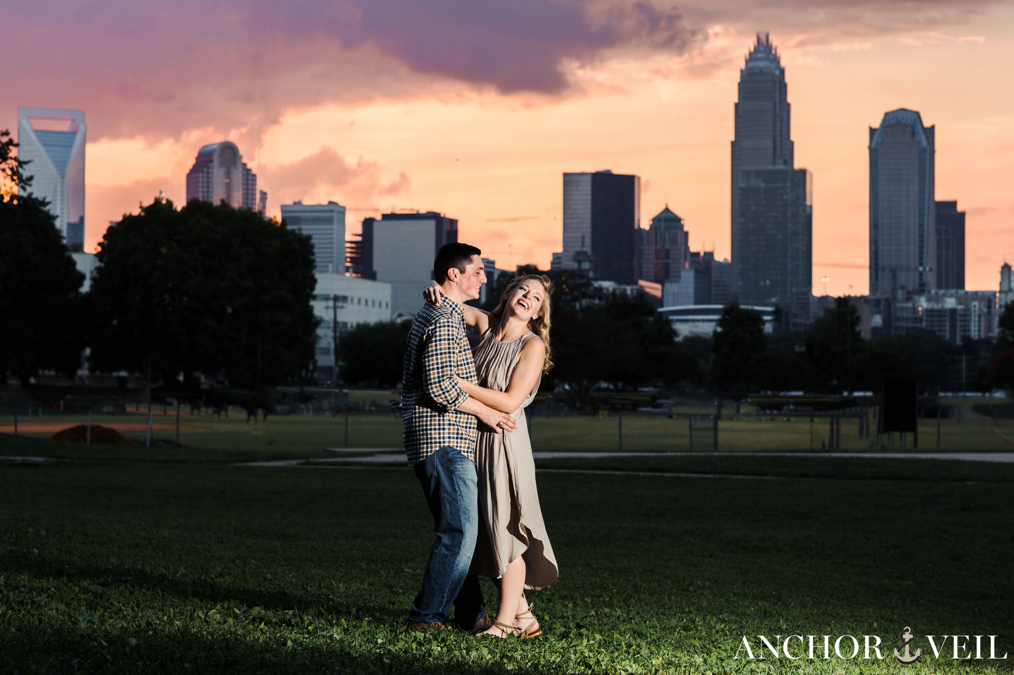 looking toward the light during the uptown charlotte engagement session with the skyline