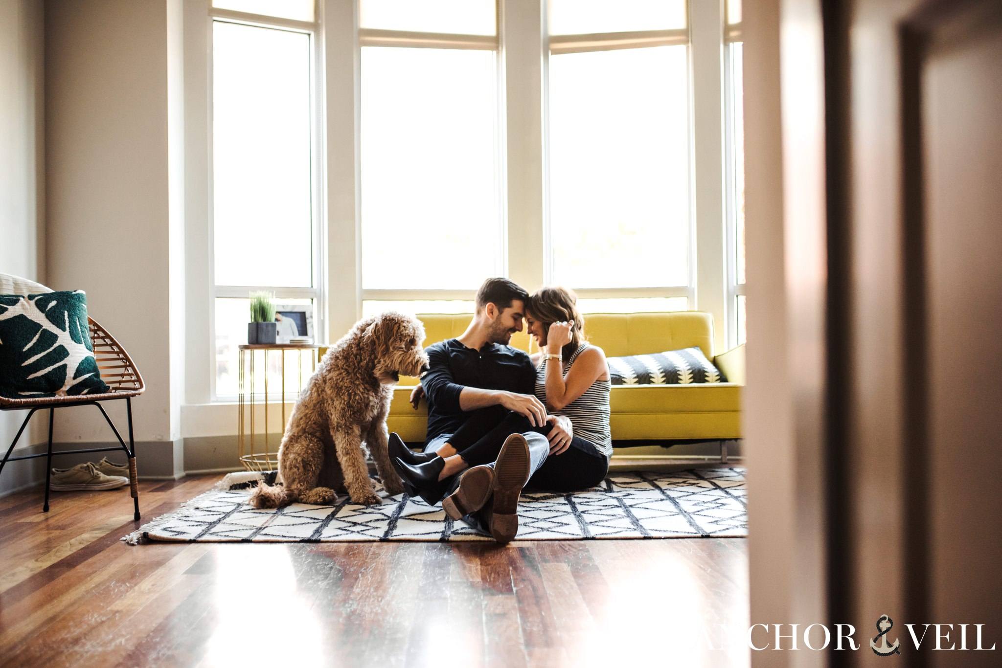 dog around them as they cuddle on the floor during the Charlotte in home session