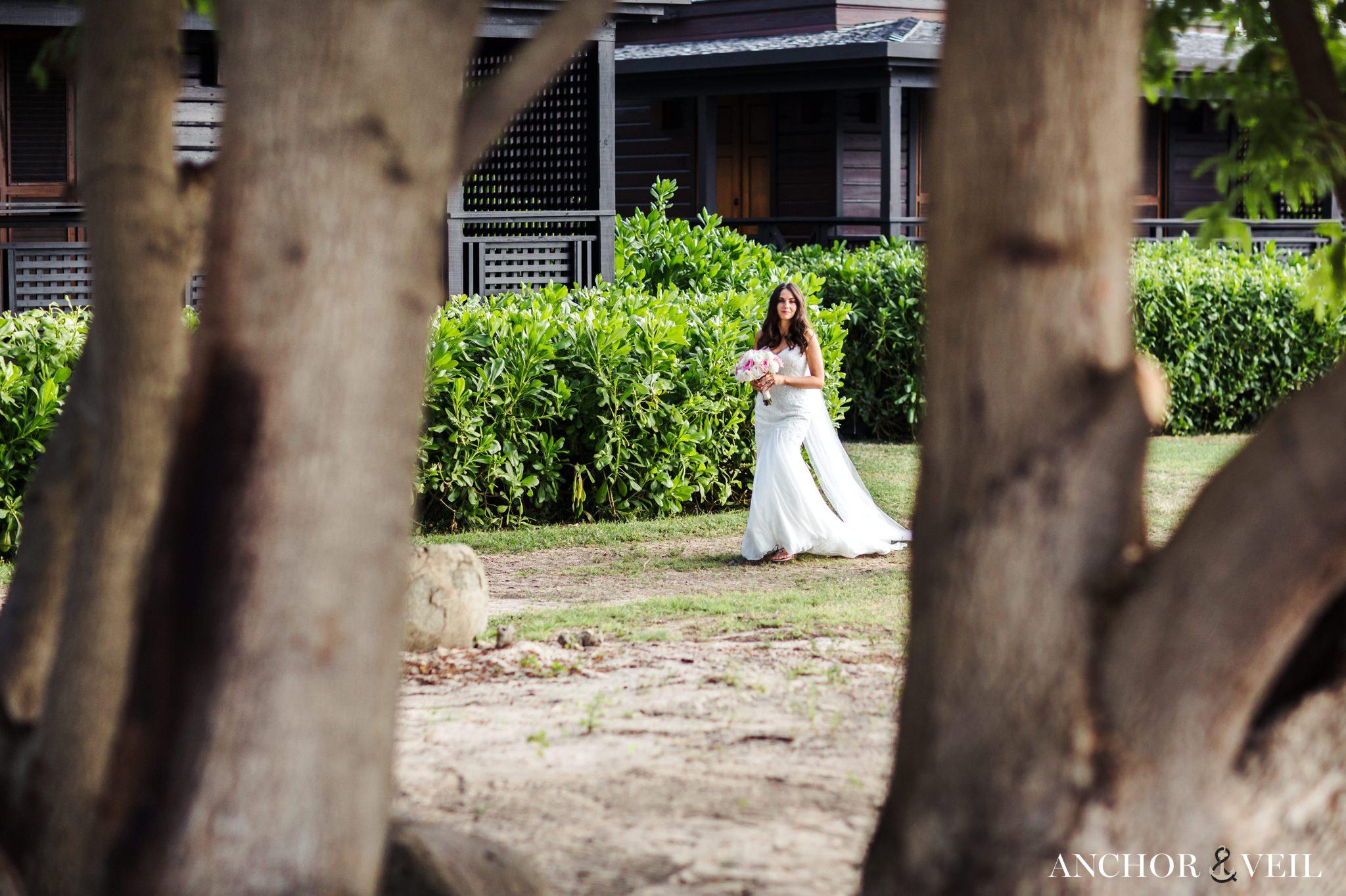 bride walking up to the ceremony location at the Hermitage Bay Antigua Wedding