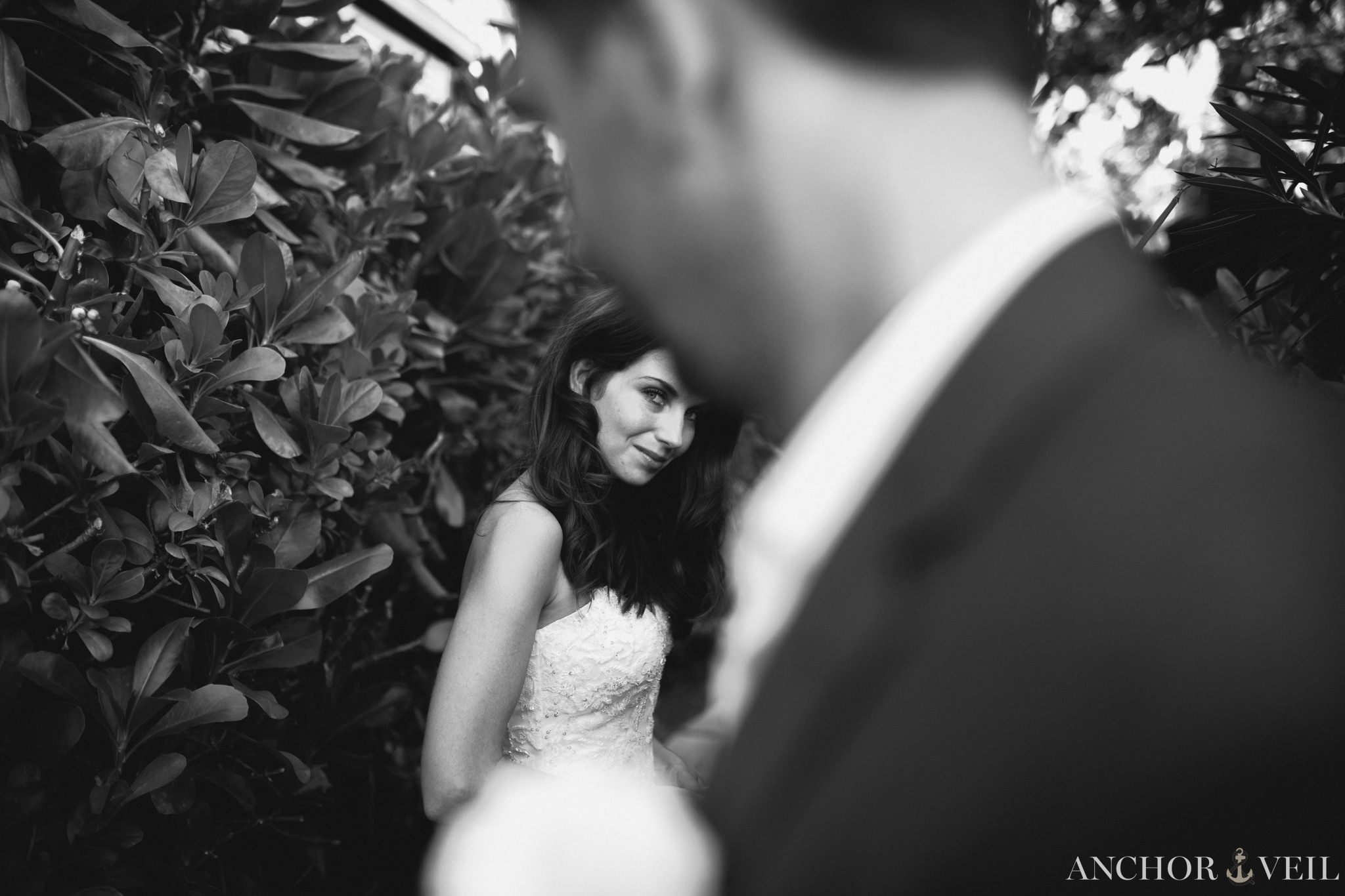 looking toward the camera past her husband at the Hermitage Bay Antigua Wedding