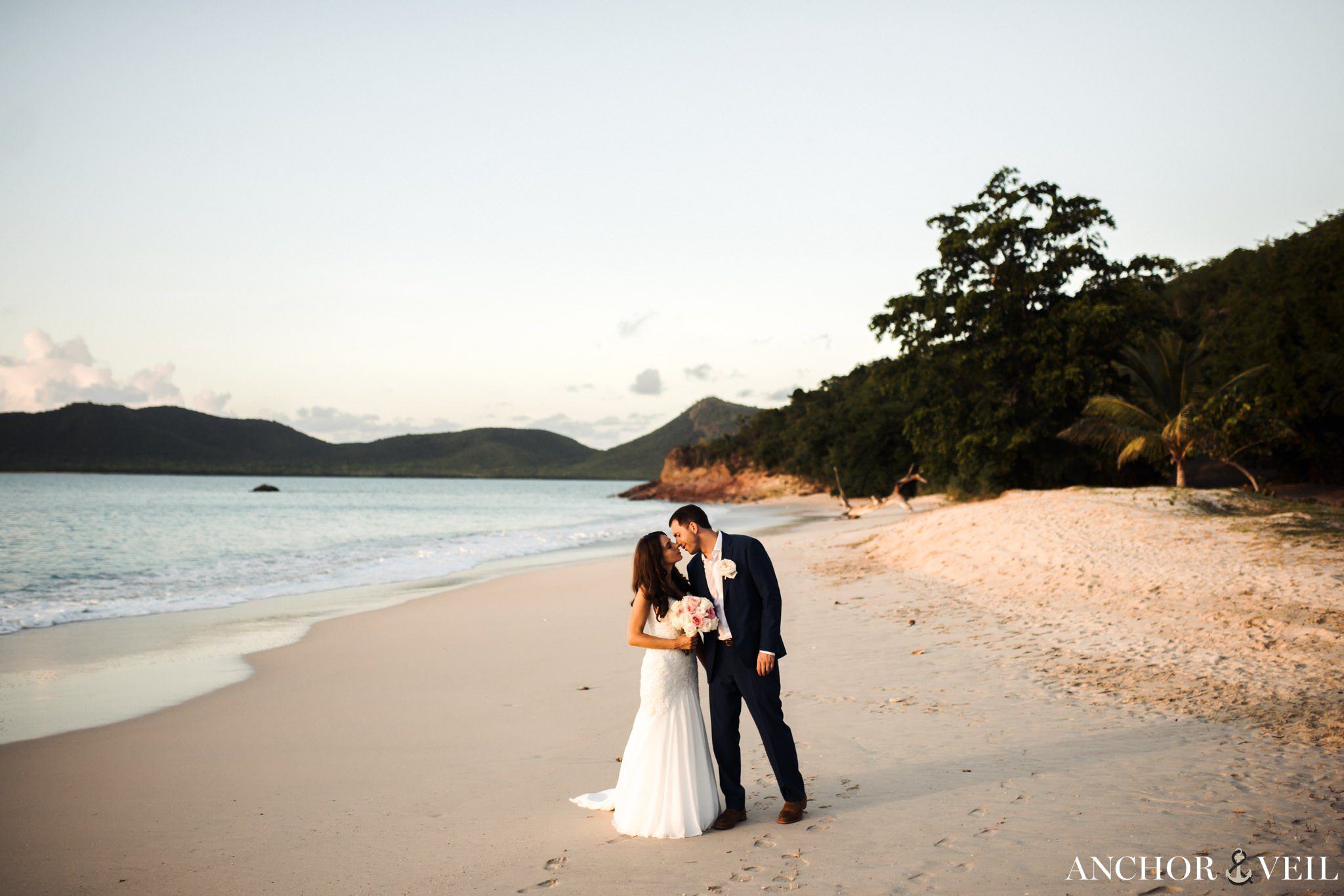 standing and walking on the beach at Hermitage Bay Antigua Wedding