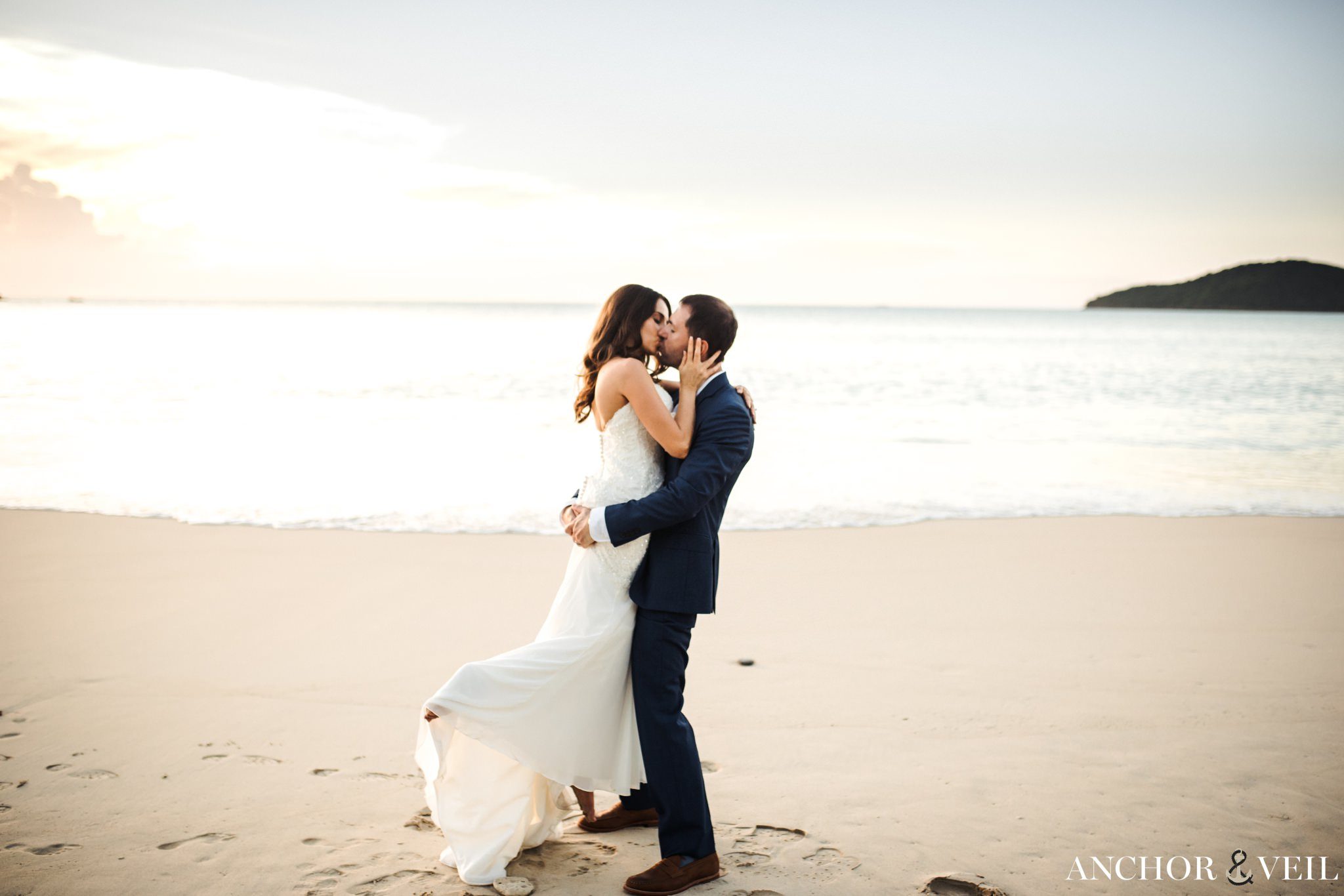 lifting her up on the beach during the Hermitage Bay Antigua Wedding