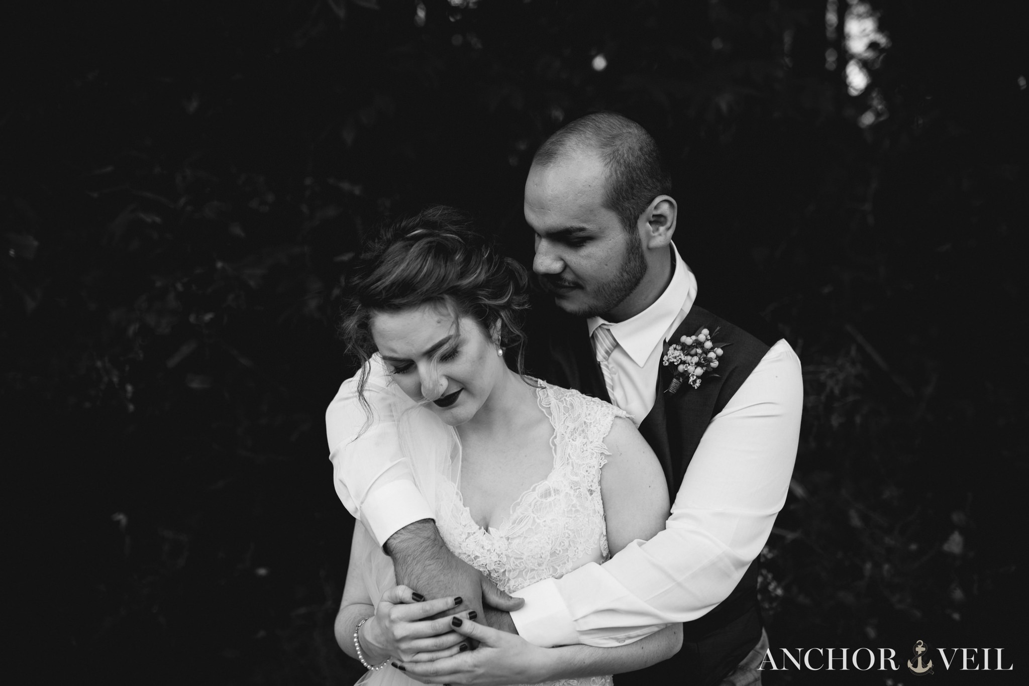 groom holding bride as her hair moves during the Hunting Creek Farms Wedding