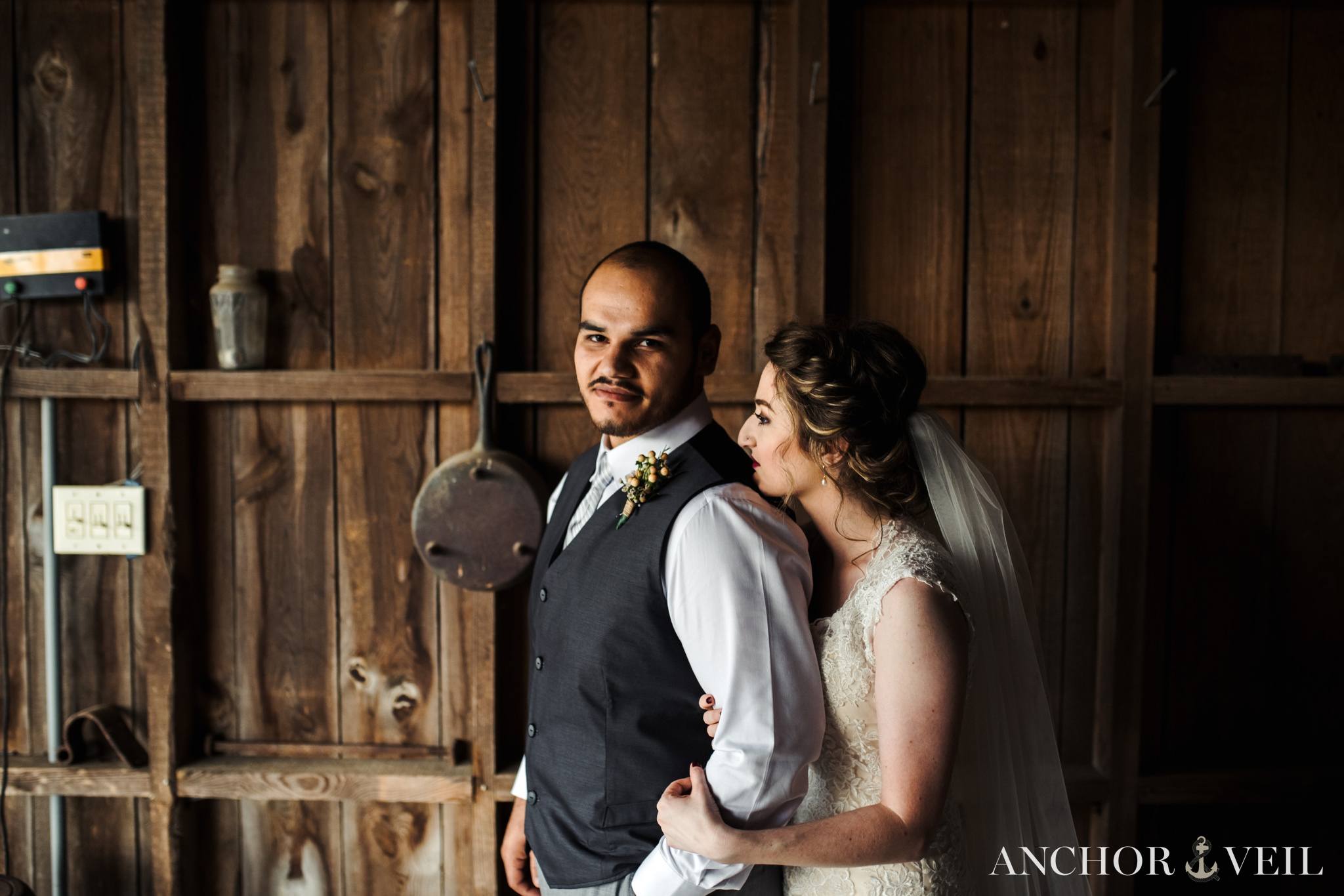 holding onto his arm in the barn during the Hunting Creek Farms Wedding