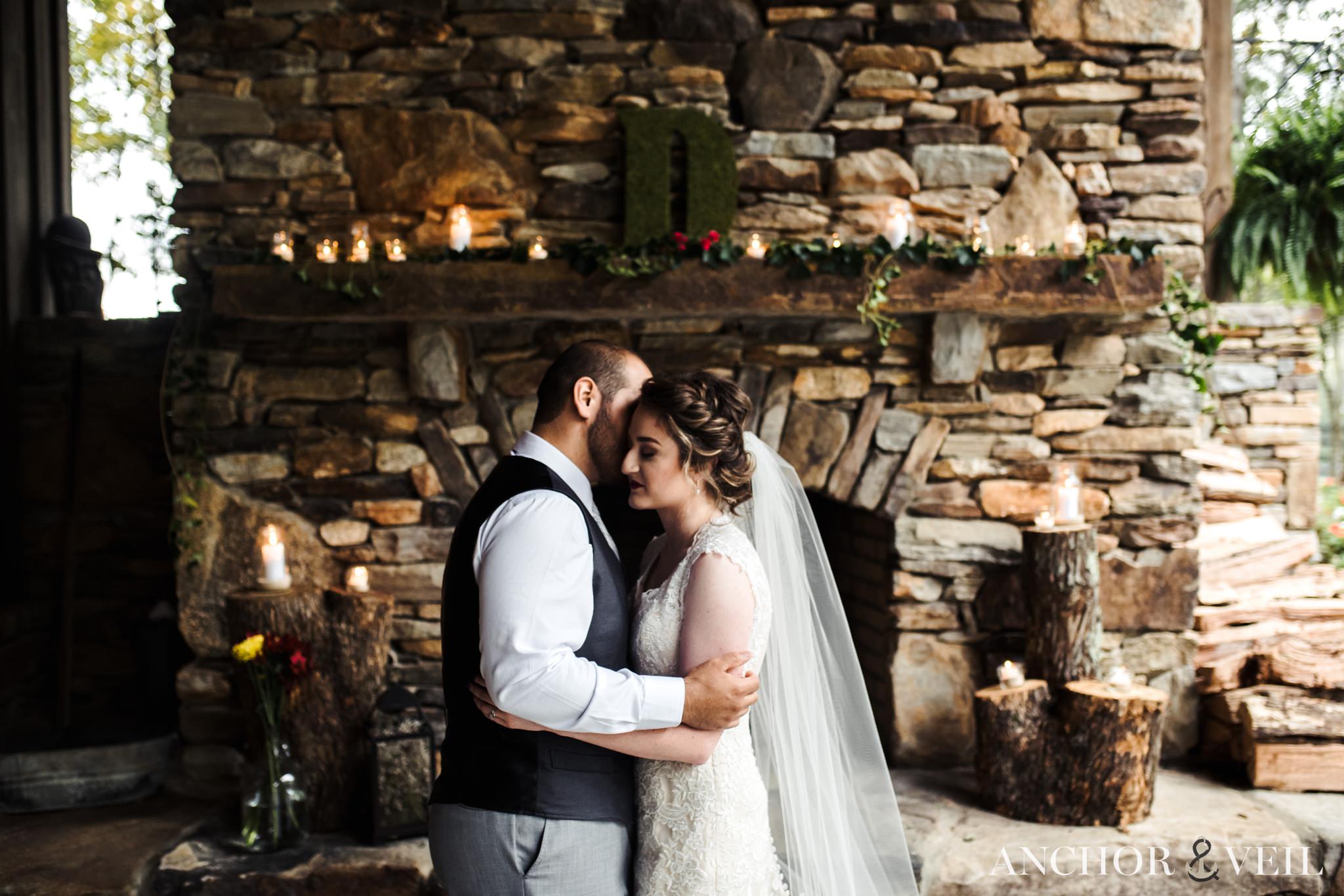 near the stone fireplace at the Hunting Creek Farms Wedding