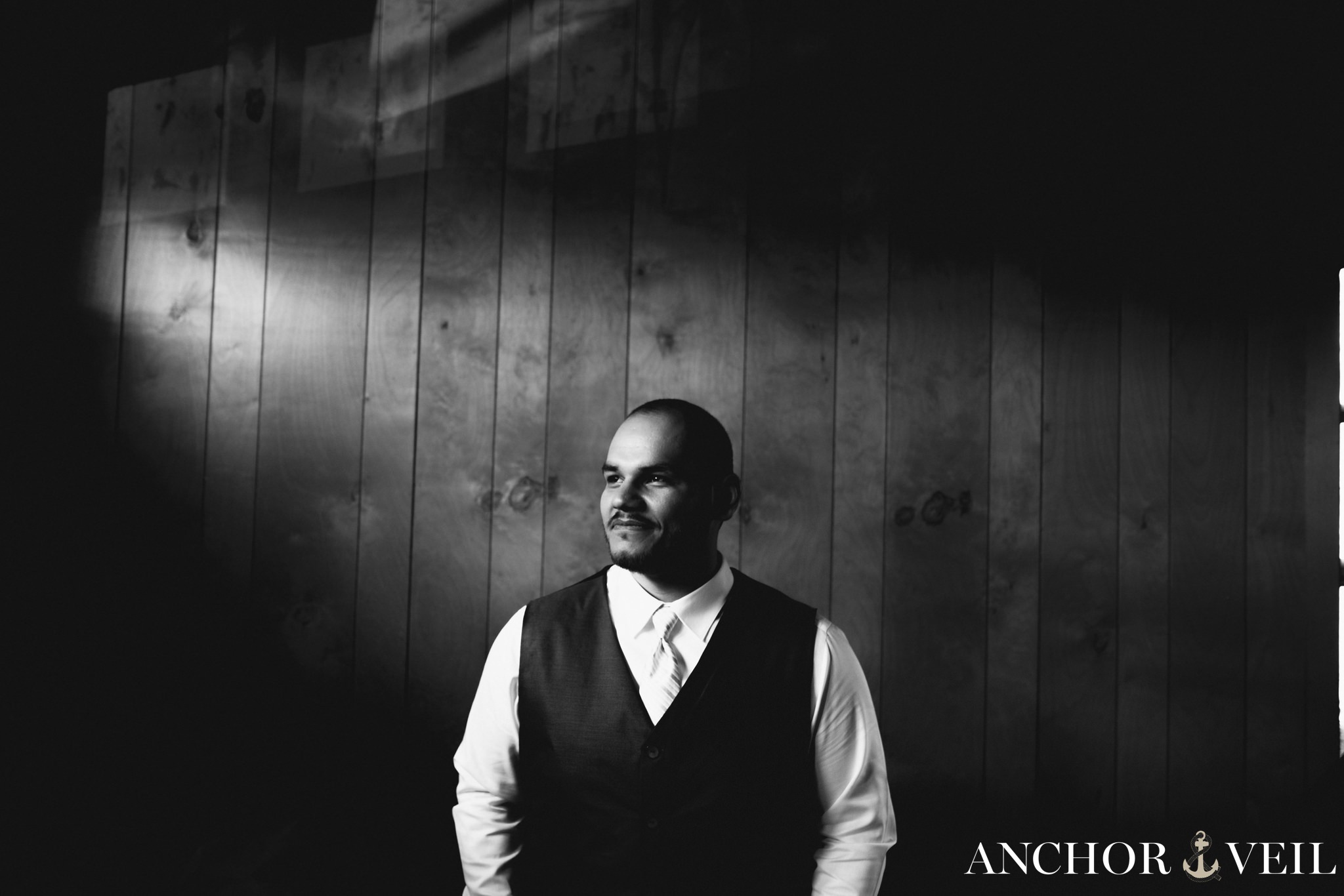 groom standing in the good light while he gets ready during the Hunting Creek Farms Wedding