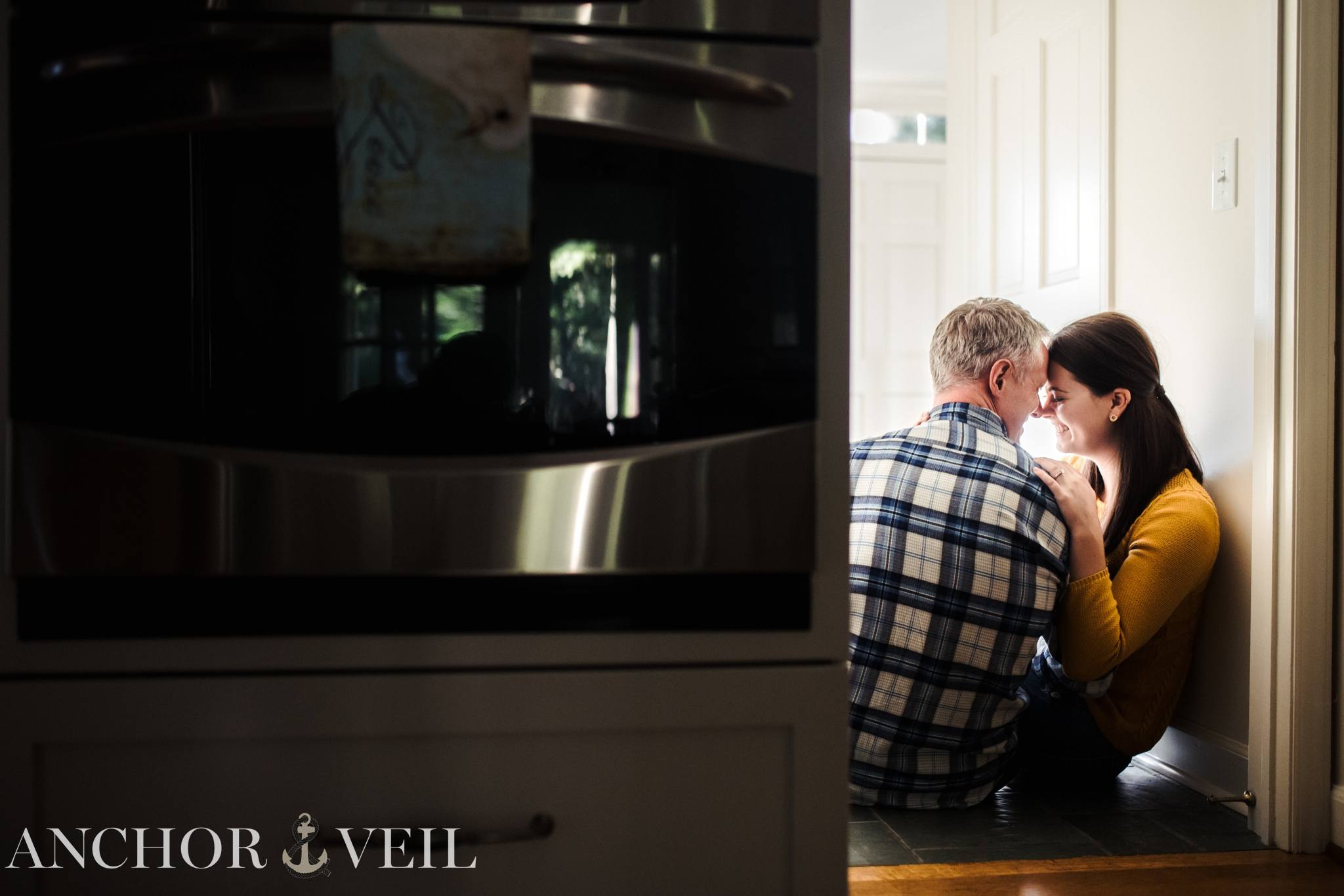 hugging against the wall during the kitchen engagement session