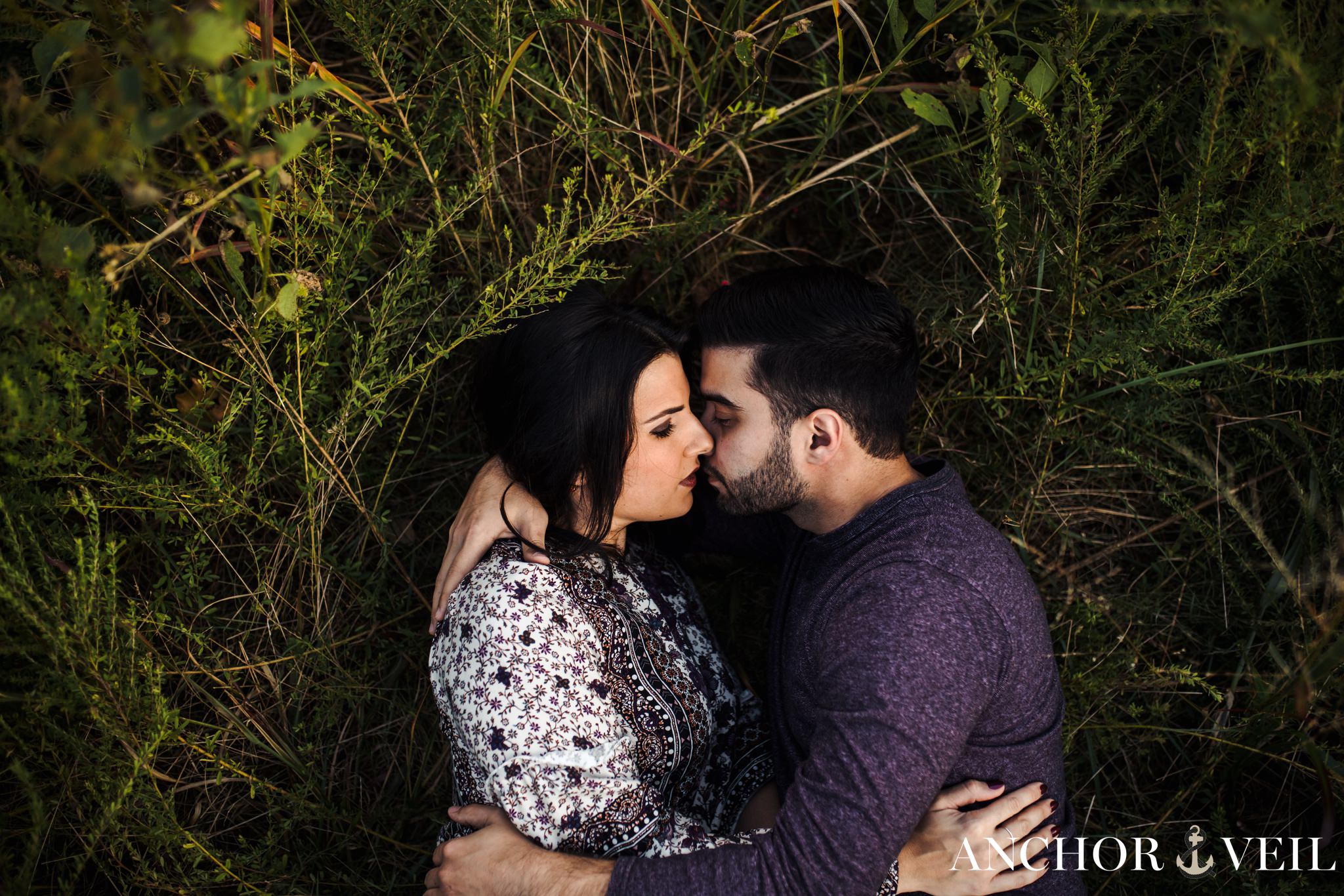 laying in the grass together during the Stone Mountain Engagement Session