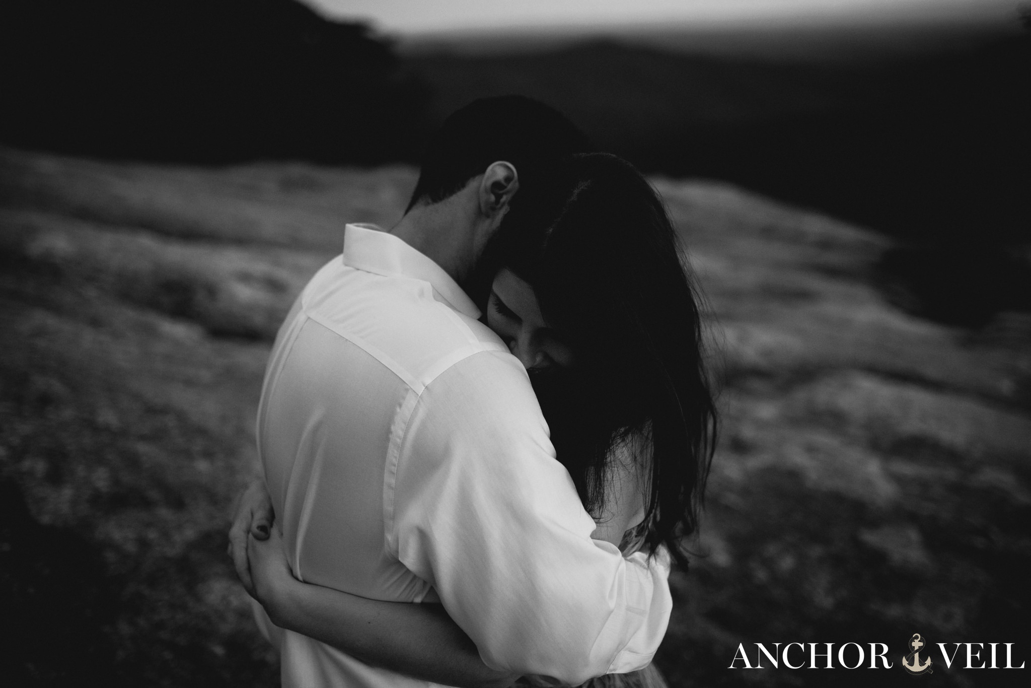 holding each other tight on the mountain during the Stone Mountain Engagement Session