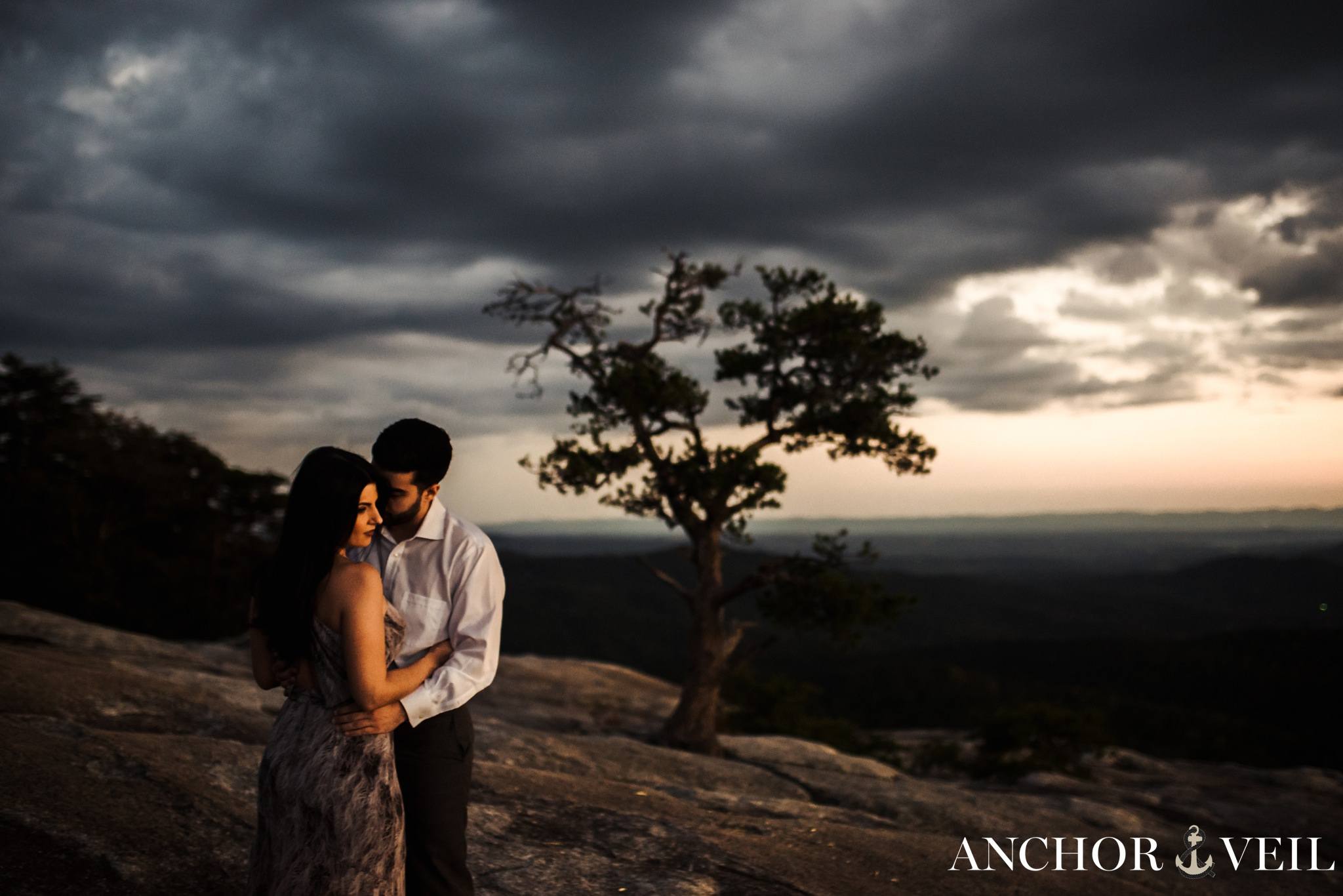 standing on the edge looking out during the Stone Mountain Engagement Session