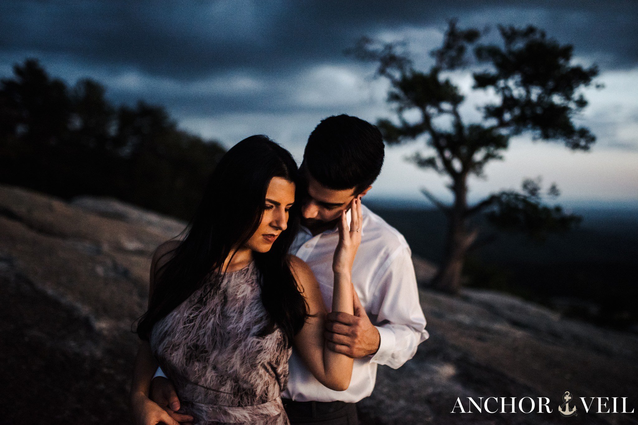 bringing his face toward hers with the light during the Stone Mountain Engagement Session