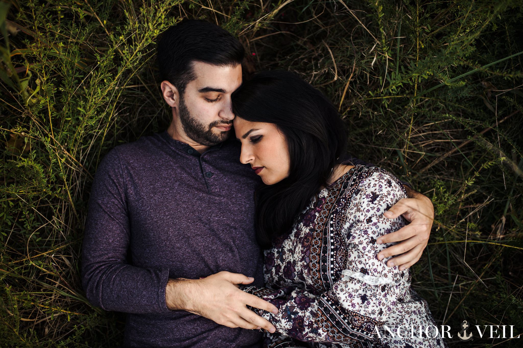 laying on his chest in the grass during the Stone Mountain Engagement Session