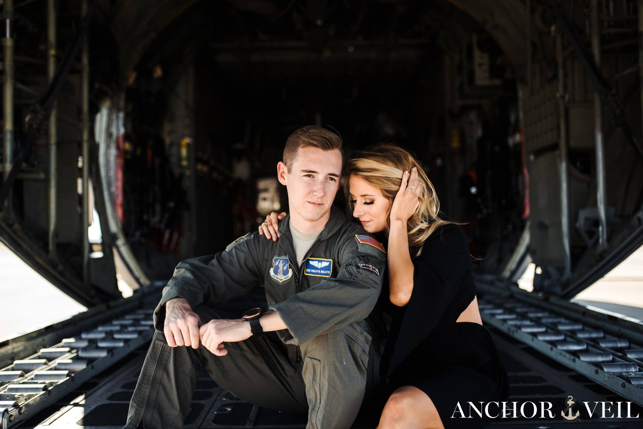 running hands through hair during the aviation themed engagement session in Charlotte NC