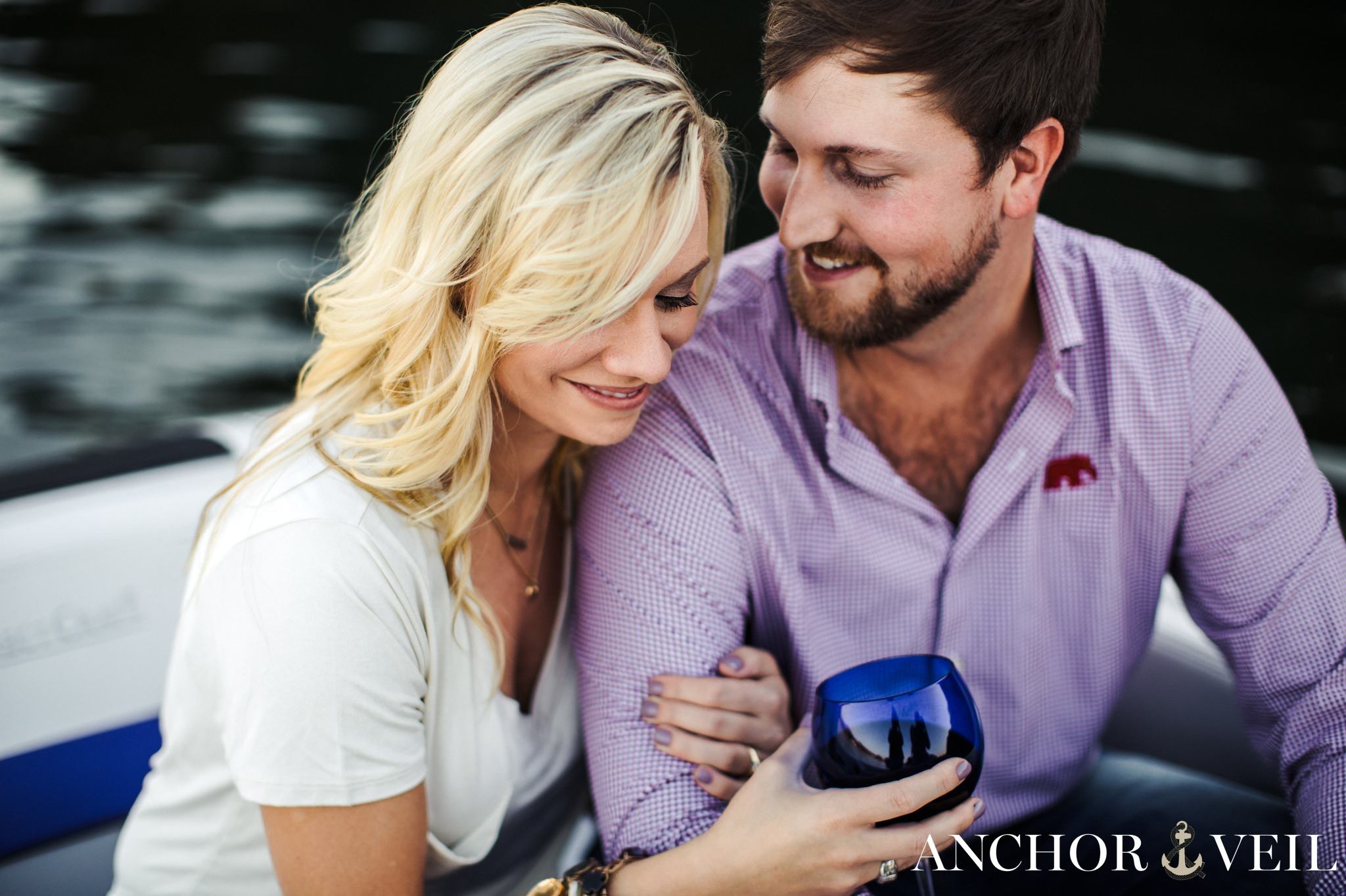 drinking wine on the boat during the belews lake engagement session
