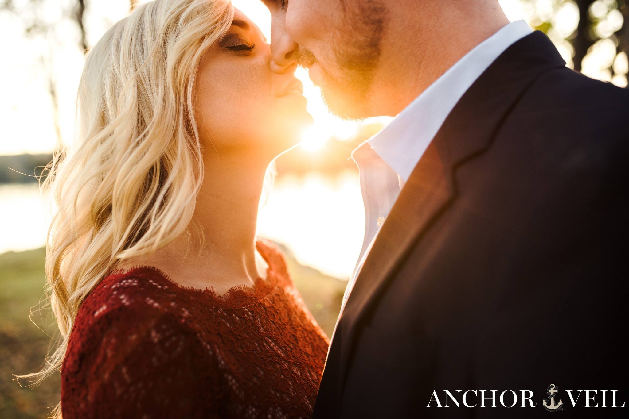 getting close to kissing with light in between during the belews lake engagement session