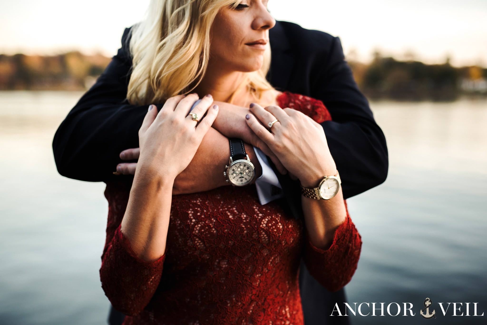 his arms over her shoulder during the belews lake engagement session