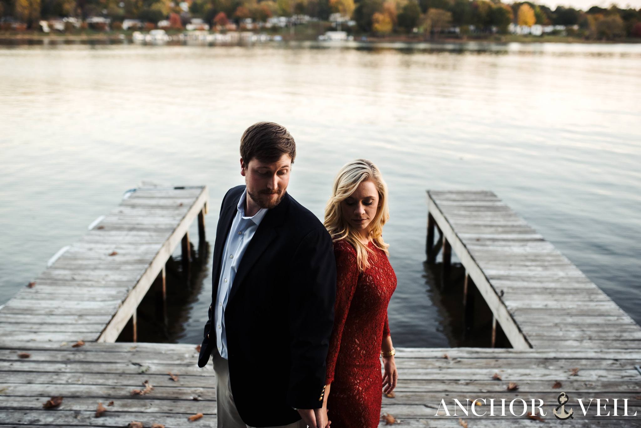shoulders to shoulders on the dock during the belews lake engagement session