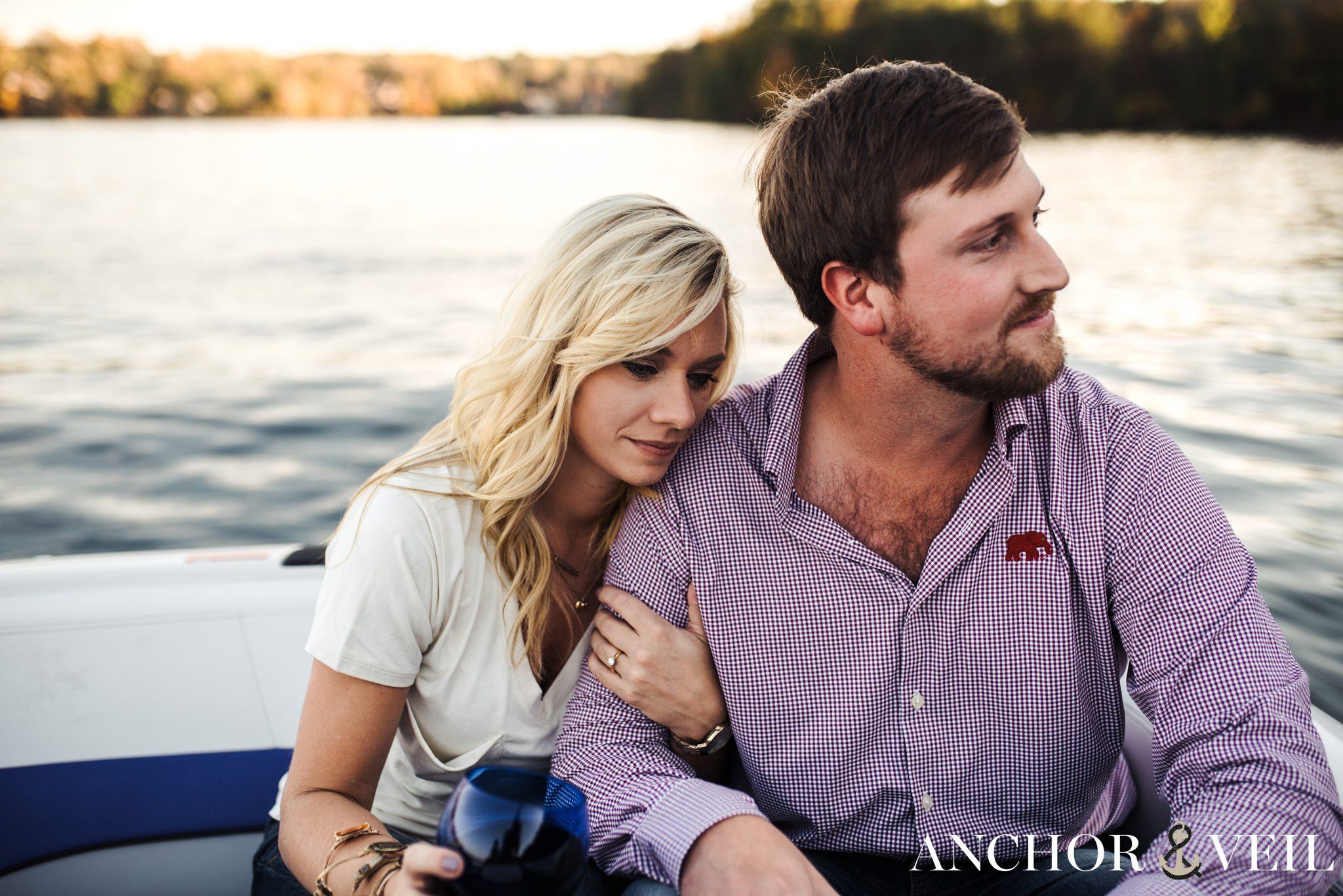 leaning on her shoulder and holding him tight during the belews lake engagement session