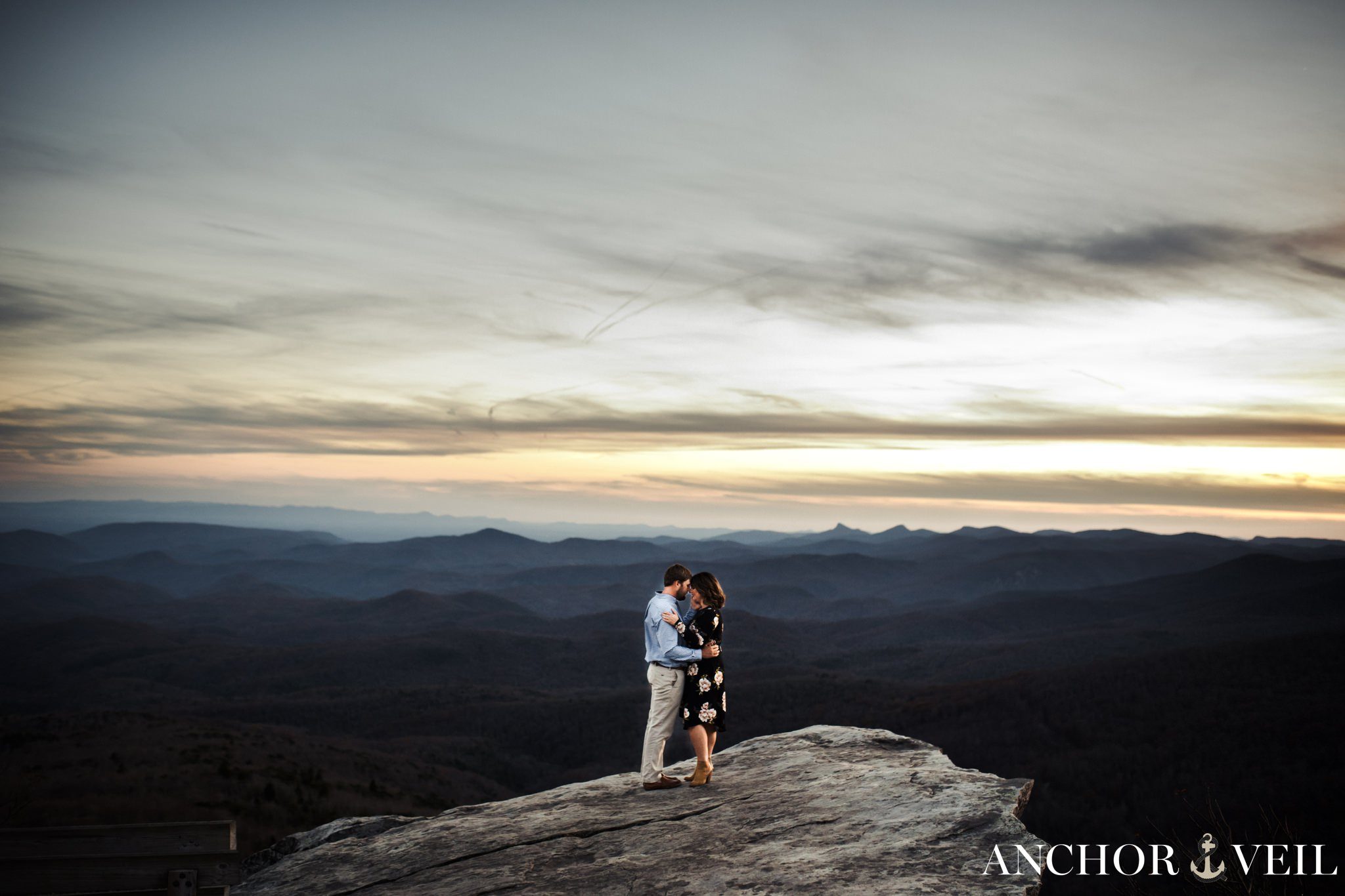 standing on the rock at rough ridge during the Blue Ridge Mountains Engagement Session