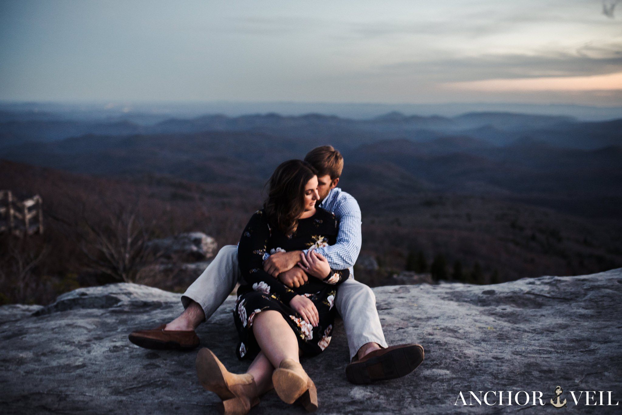 sitting on the rock and holding each other on rough ridge during the Blue Ridge Mountains Engagement 