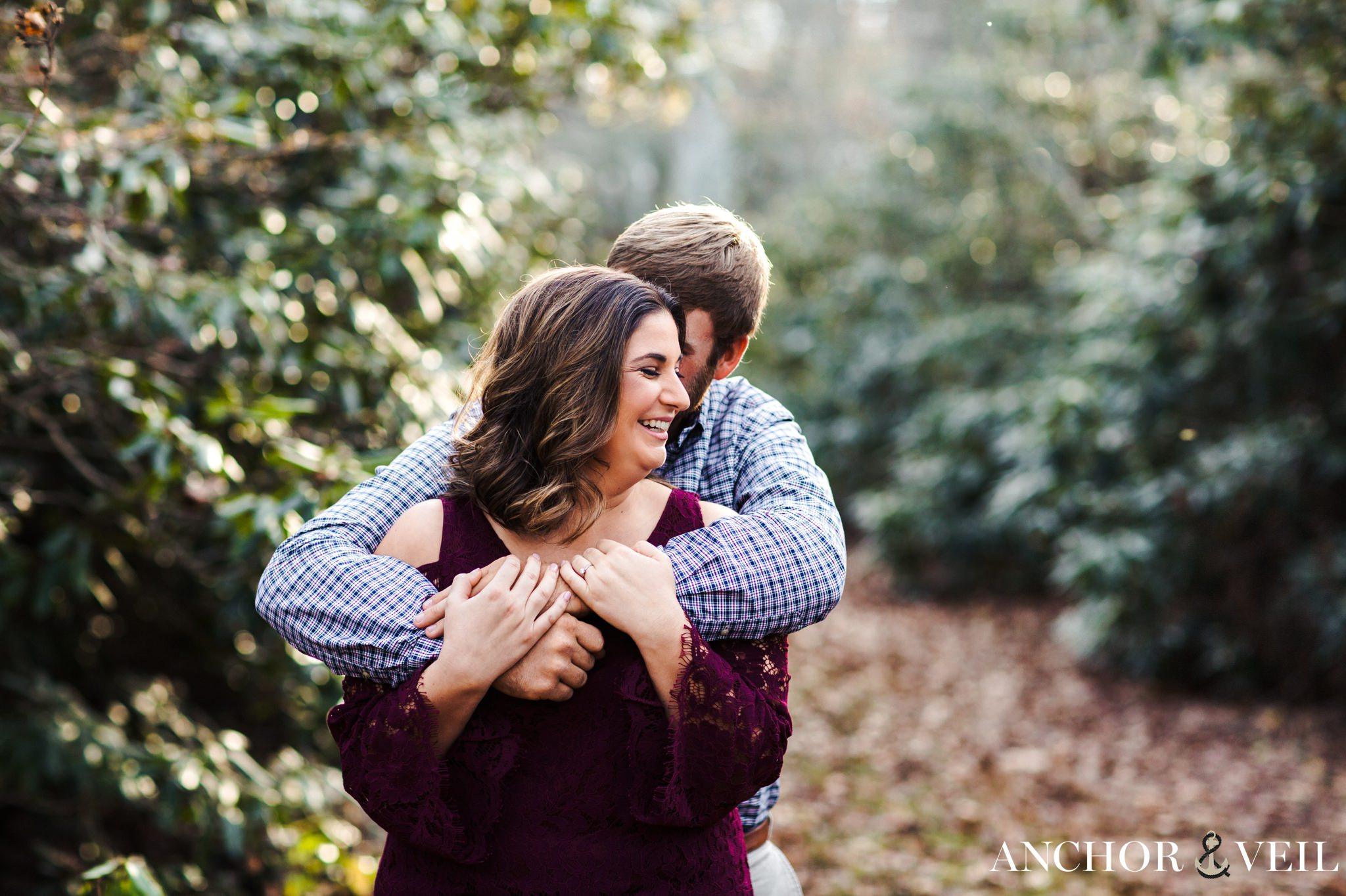 holding her from behind during the engagement Session