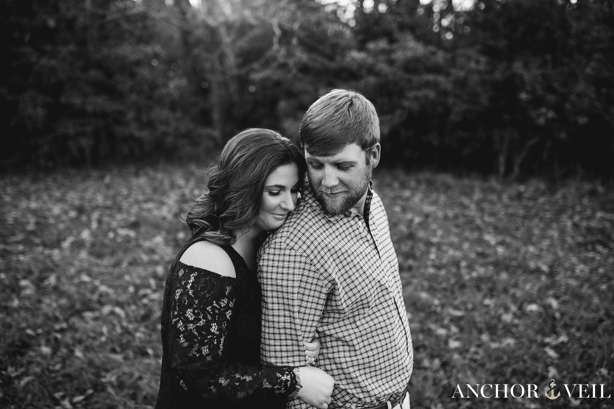 looking back to her as she holds him during this sweet engagement session