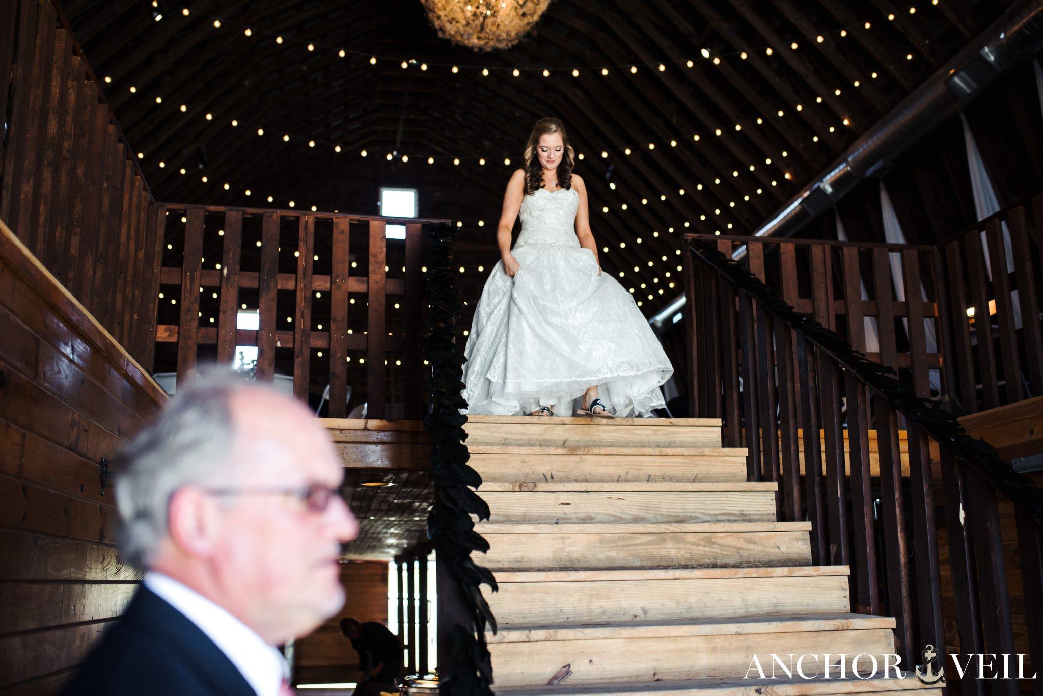 bride walking down the stairs to see her father
