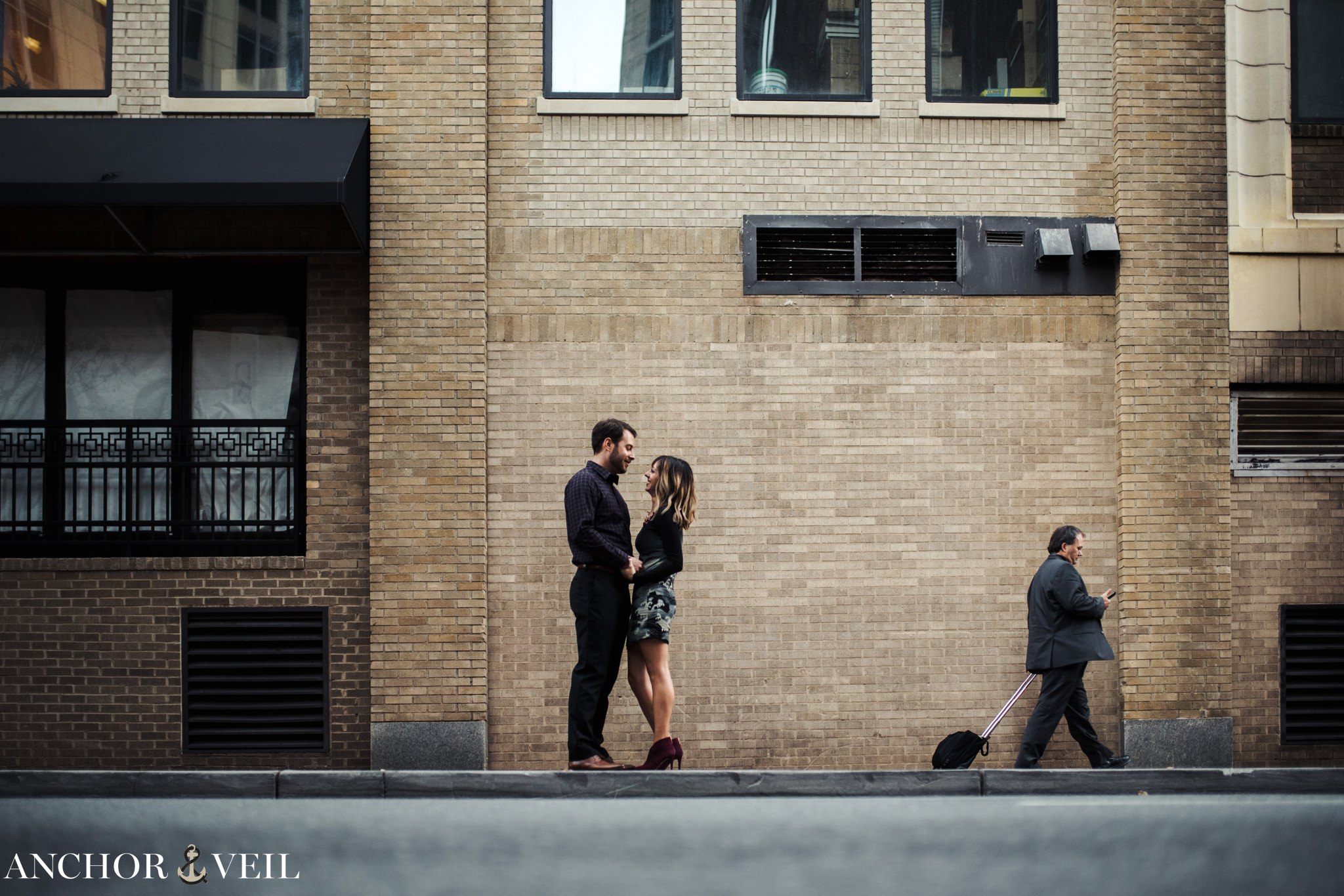 guy walking across the street during the Uptown Charlotte Engagement Session